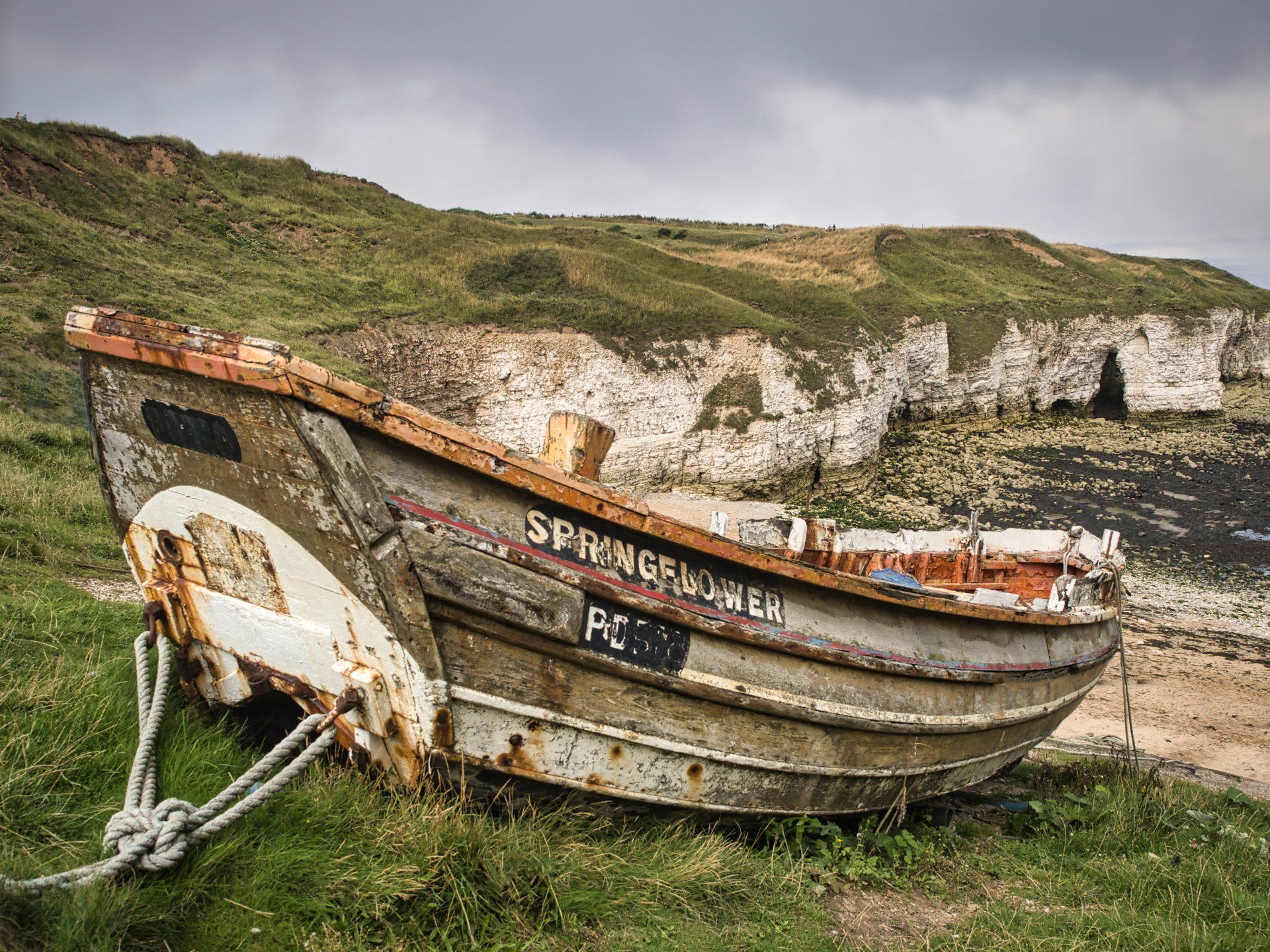 a derelict boat at the top of the beach