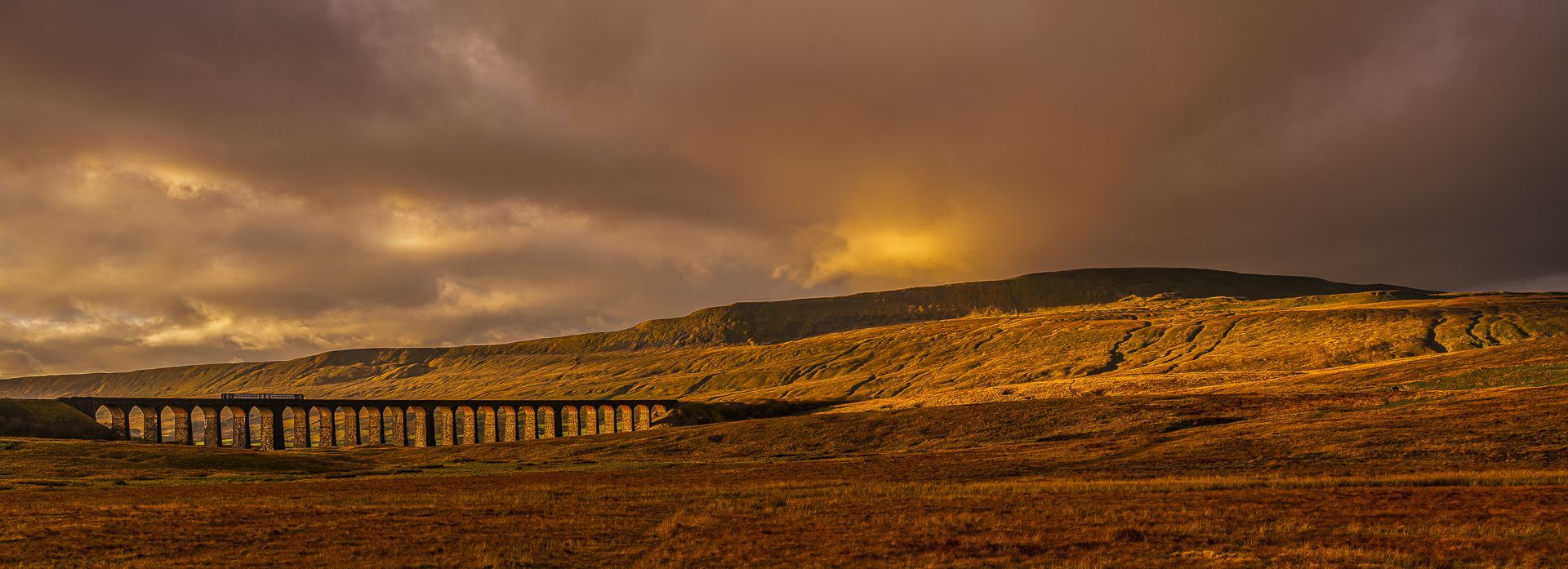 a view of Ribblehead viaduct at sunset