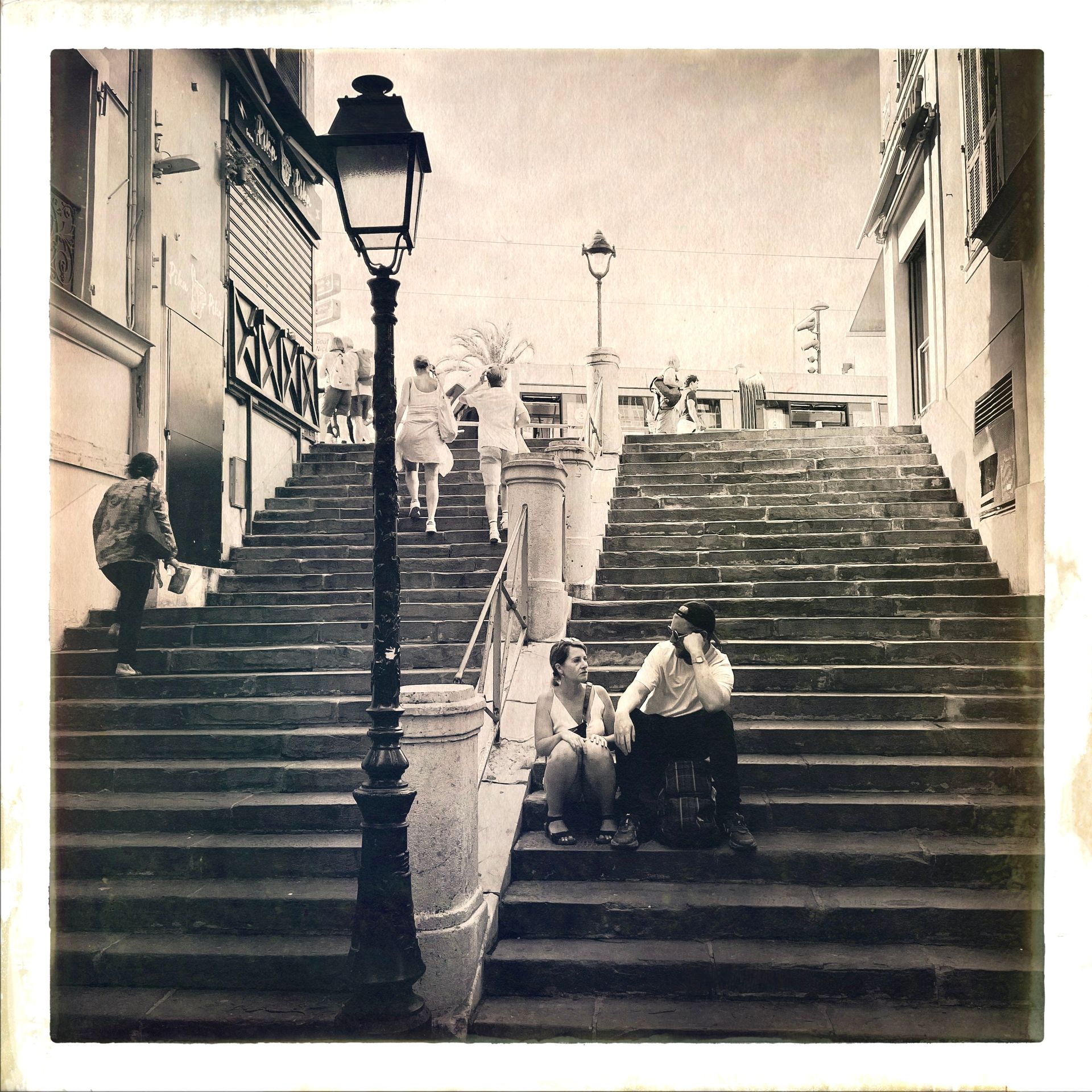 a view of a young couple sitting on some steps