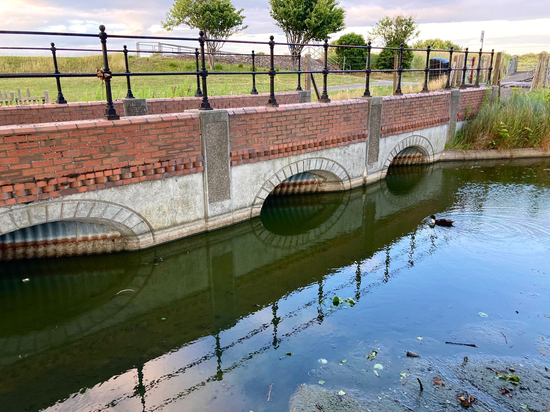 a railway culvert, reflected in the water at Cleethorpes