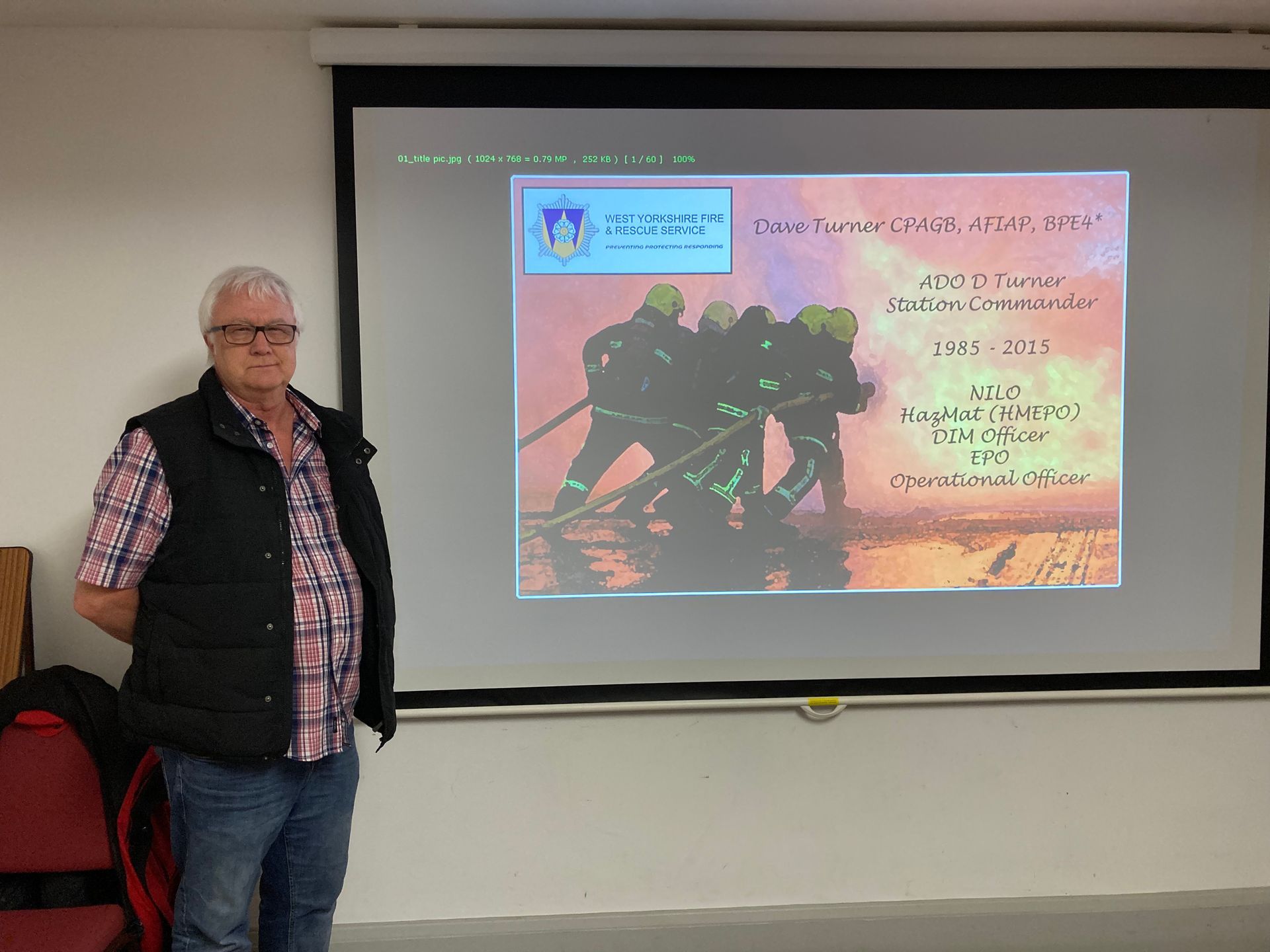 Dave Turner by Derek Smith Dave Turner beside the slideshow presentation