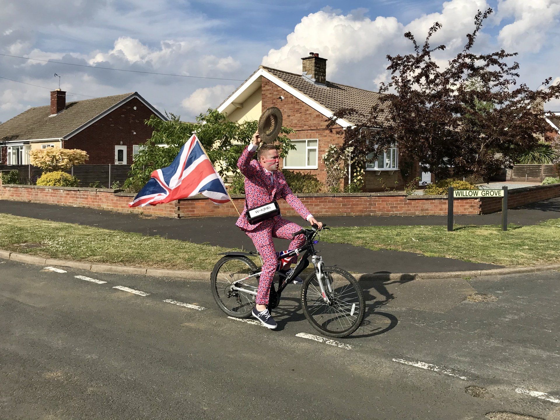 ve day street party cyclist waving the union jack