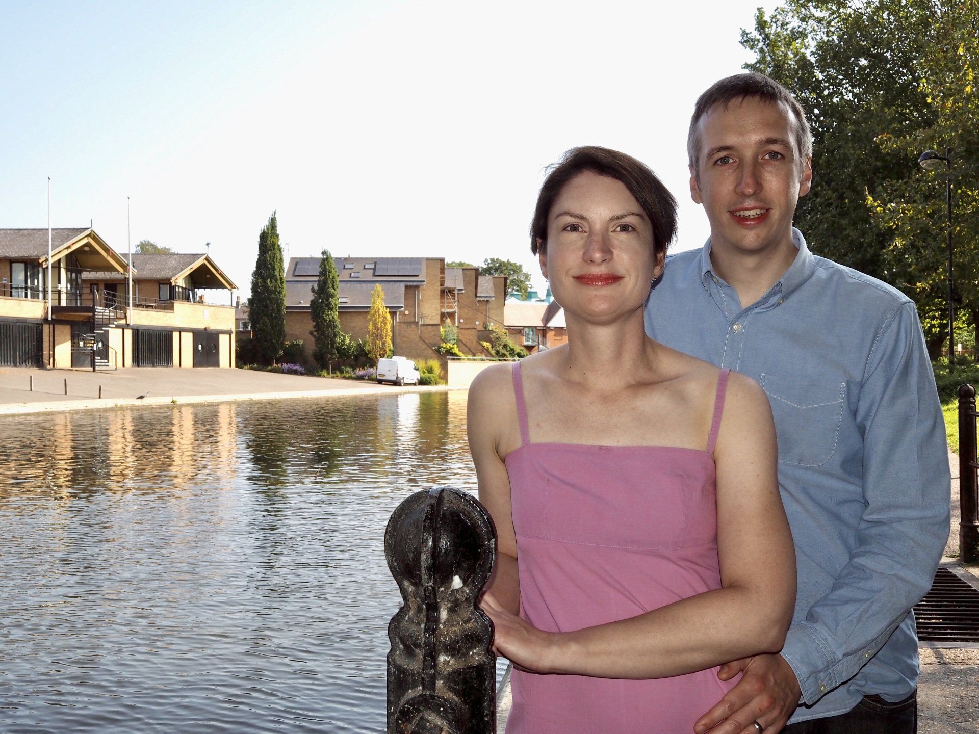 a couple standing beside a river