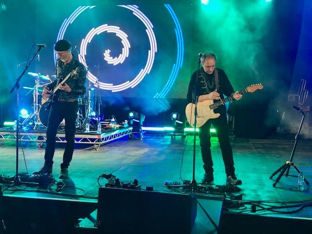 Two musicians on stage at a music festival