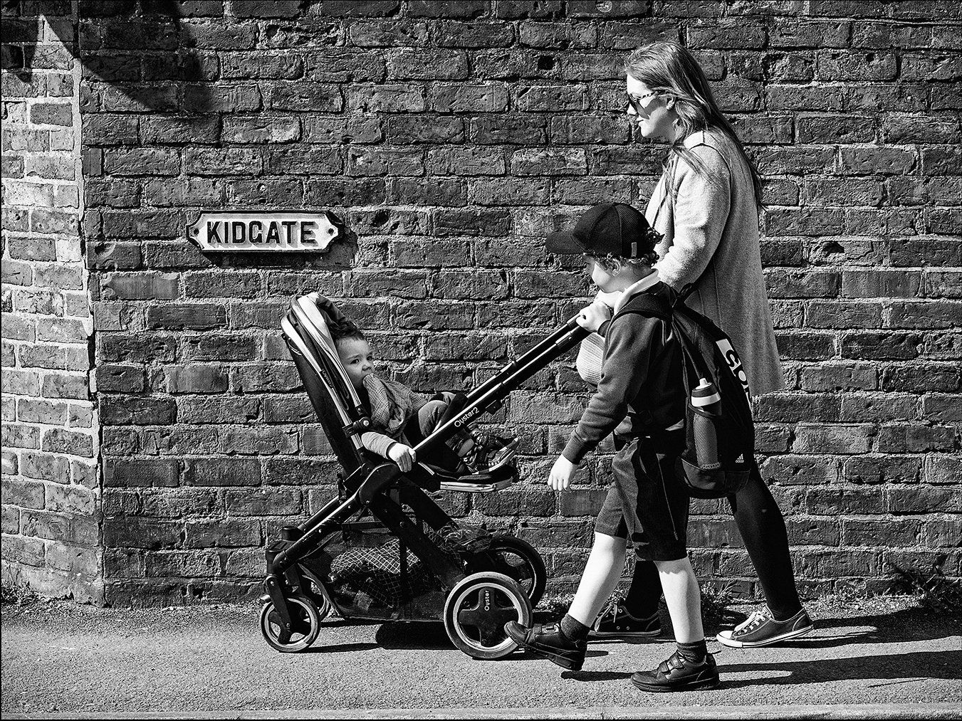 a mother walking children to school