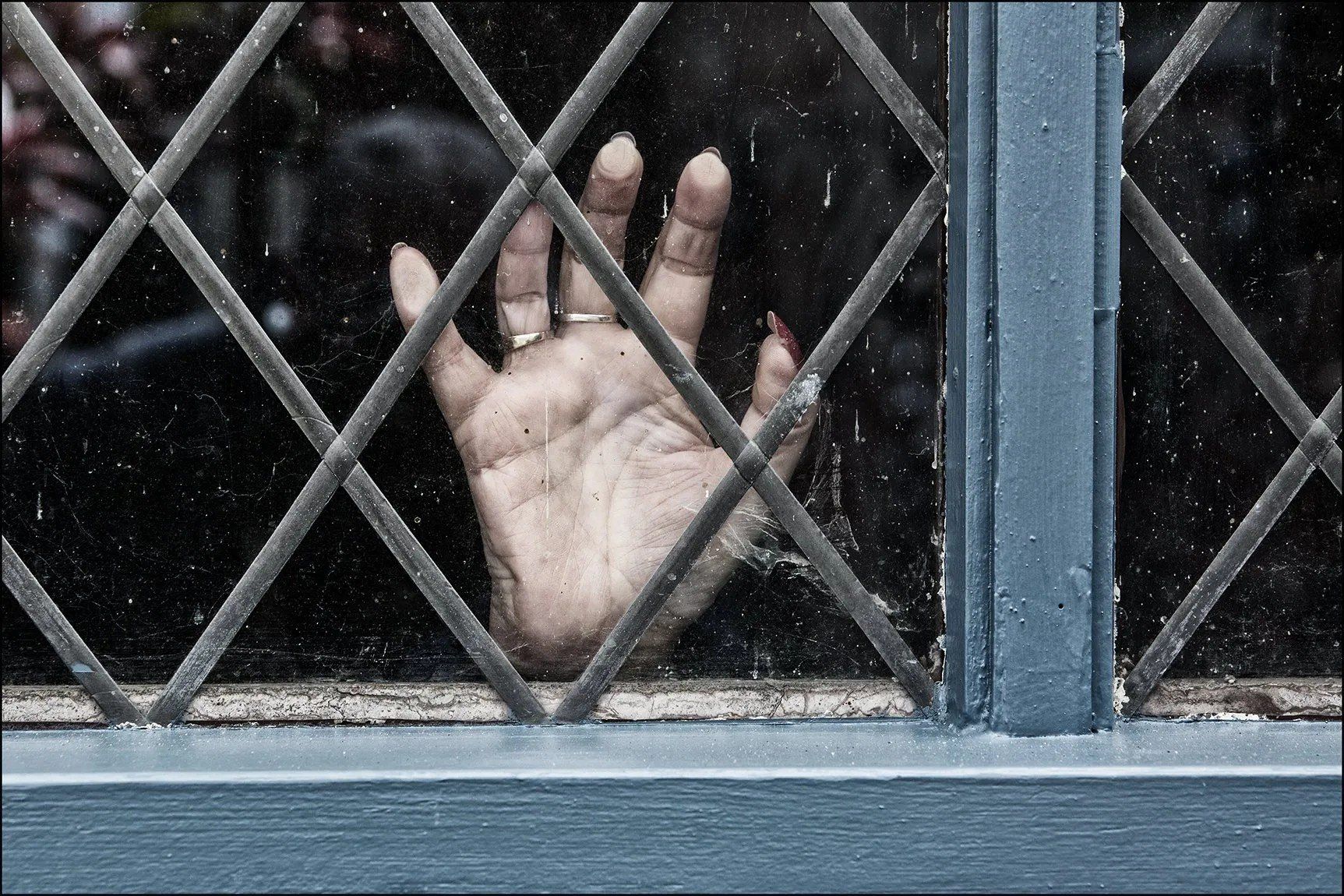 Isolated Desperation by Paul Malley a hand at a window