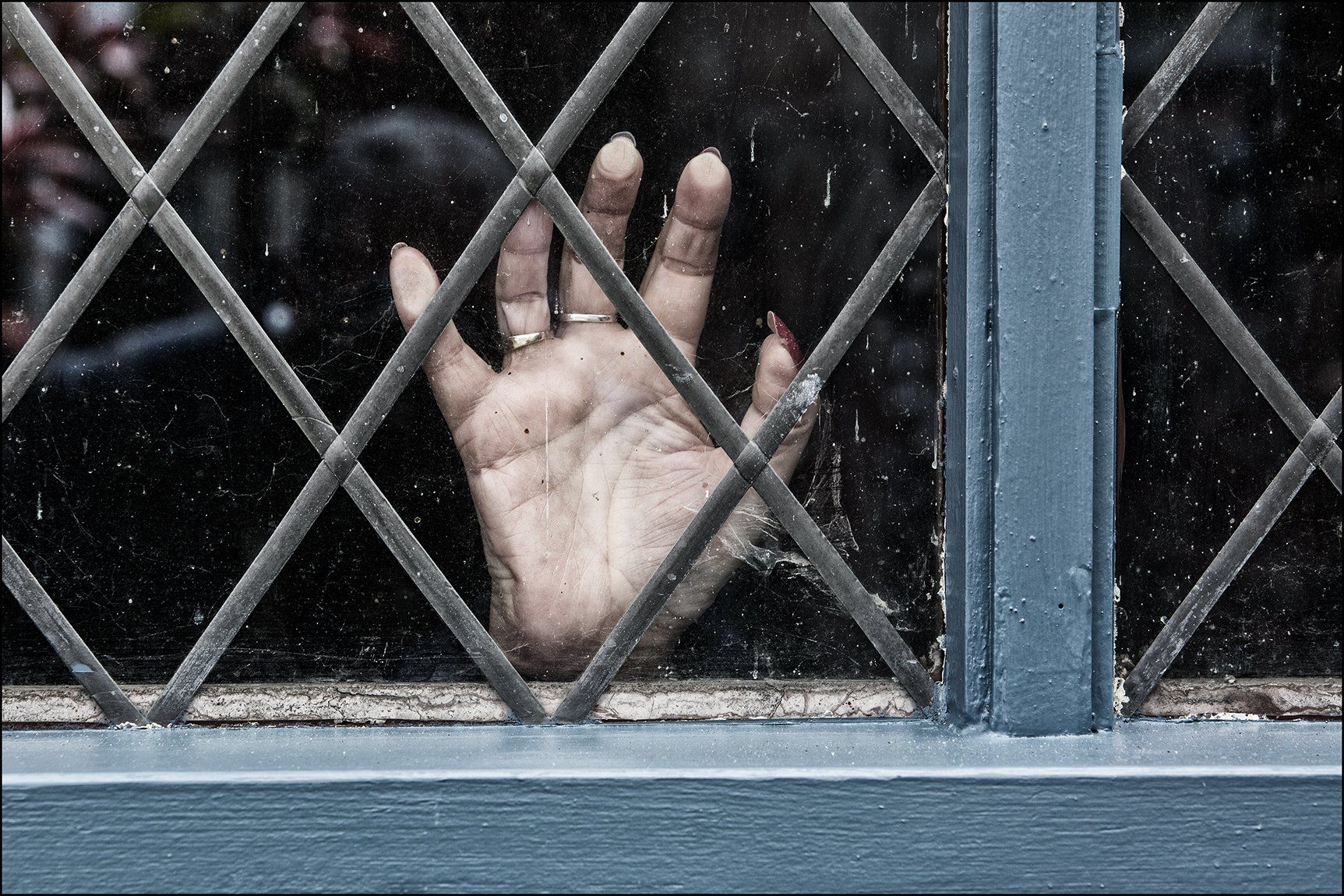Photo by: Paul Malley a hand at a window
