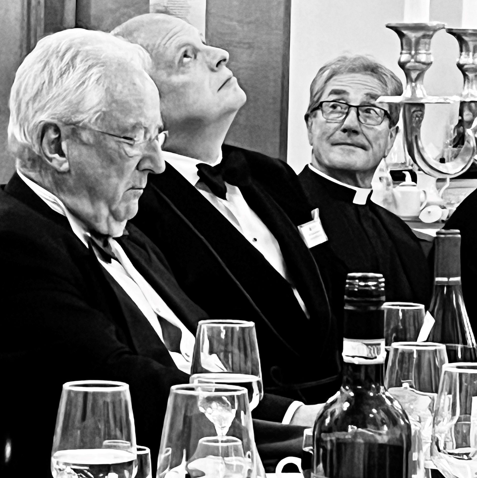 a photo of attendees at a meeting listening to a speech