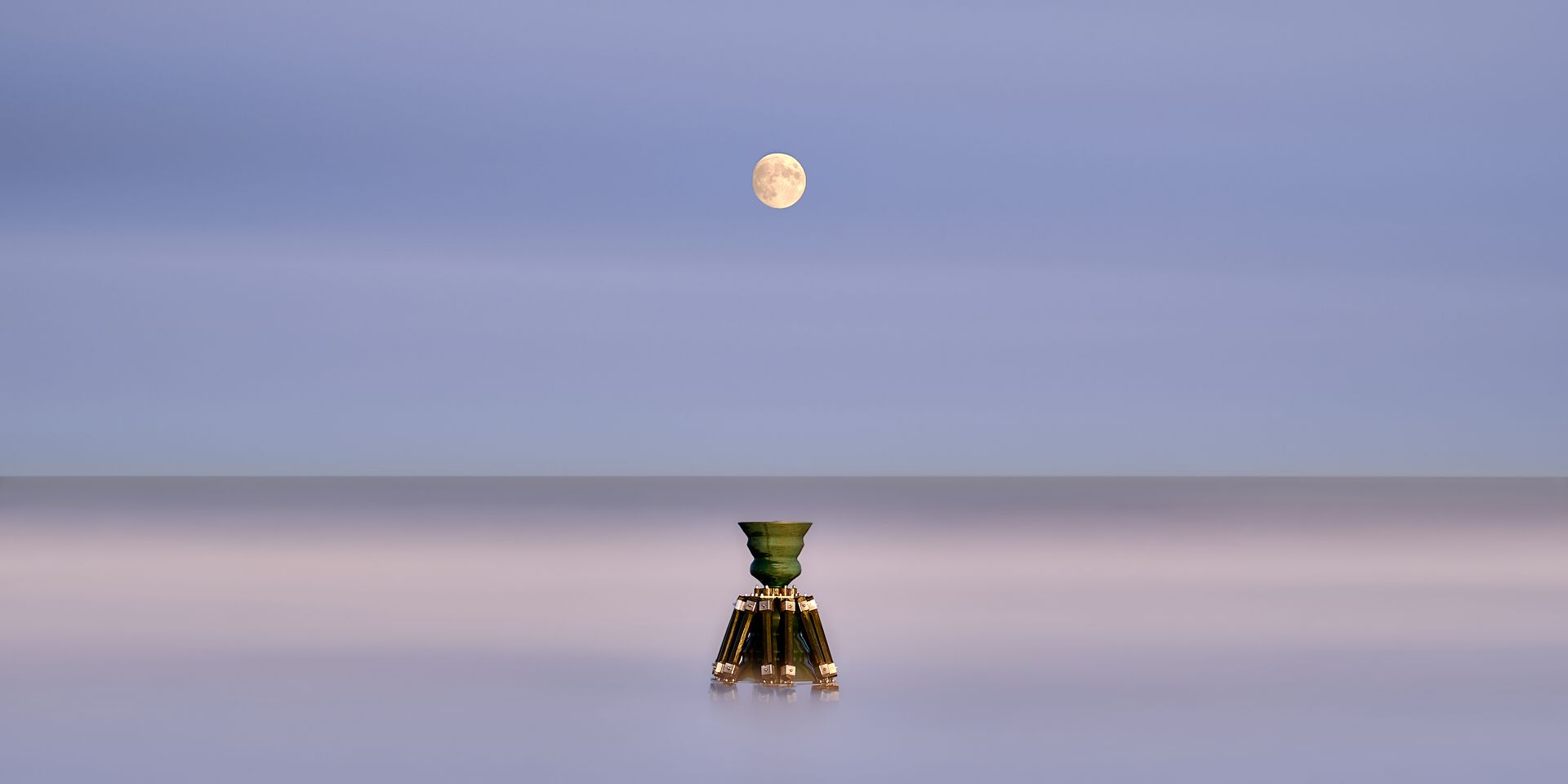 A man's shadow reflection on a wet pavement
