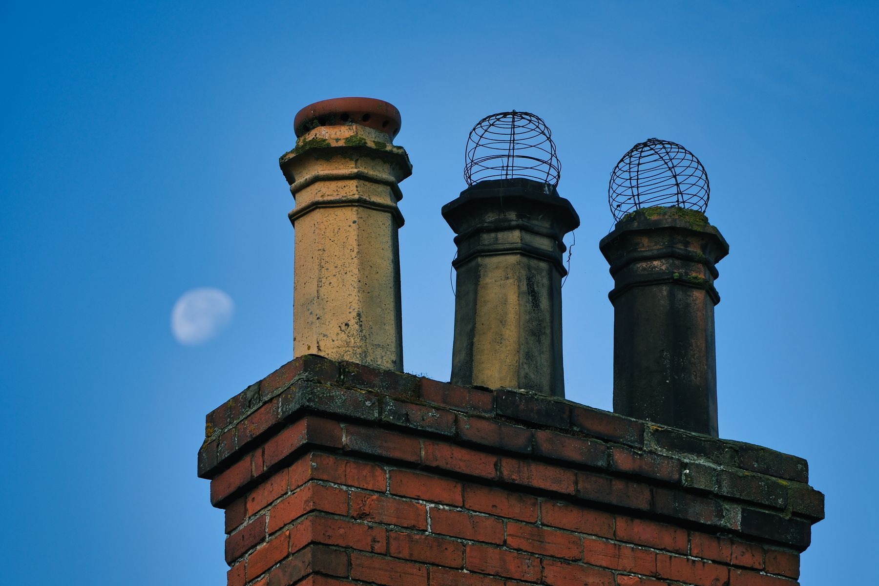a chimney stack with 3 pots