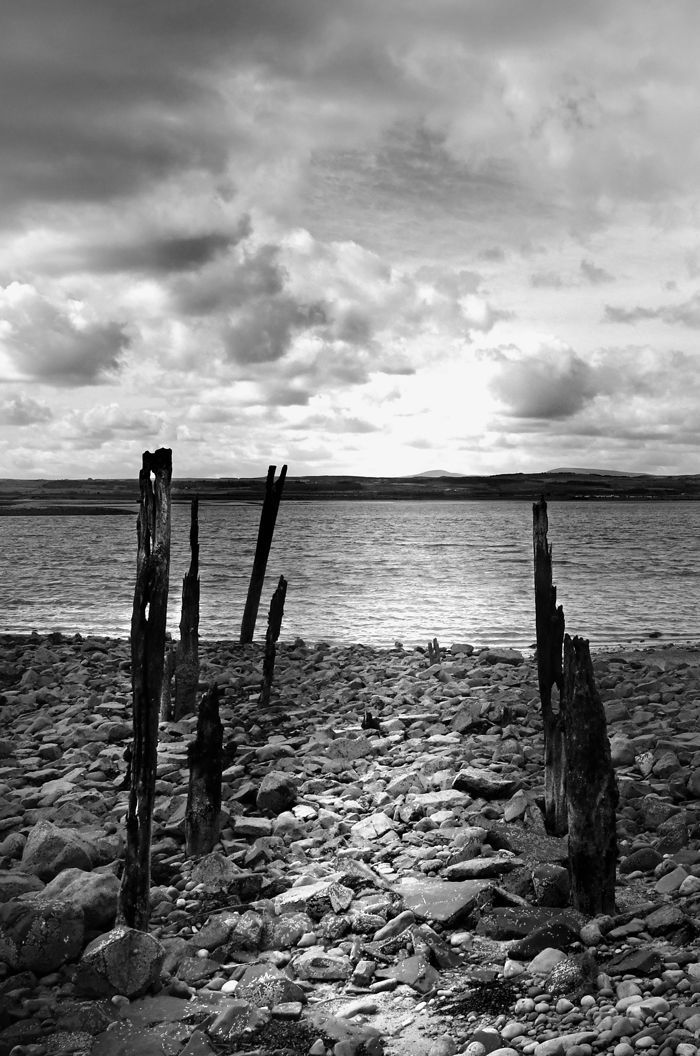 Old Beach Structures by Graham Harrison Monochrome view of the beach on Lindisfarne island