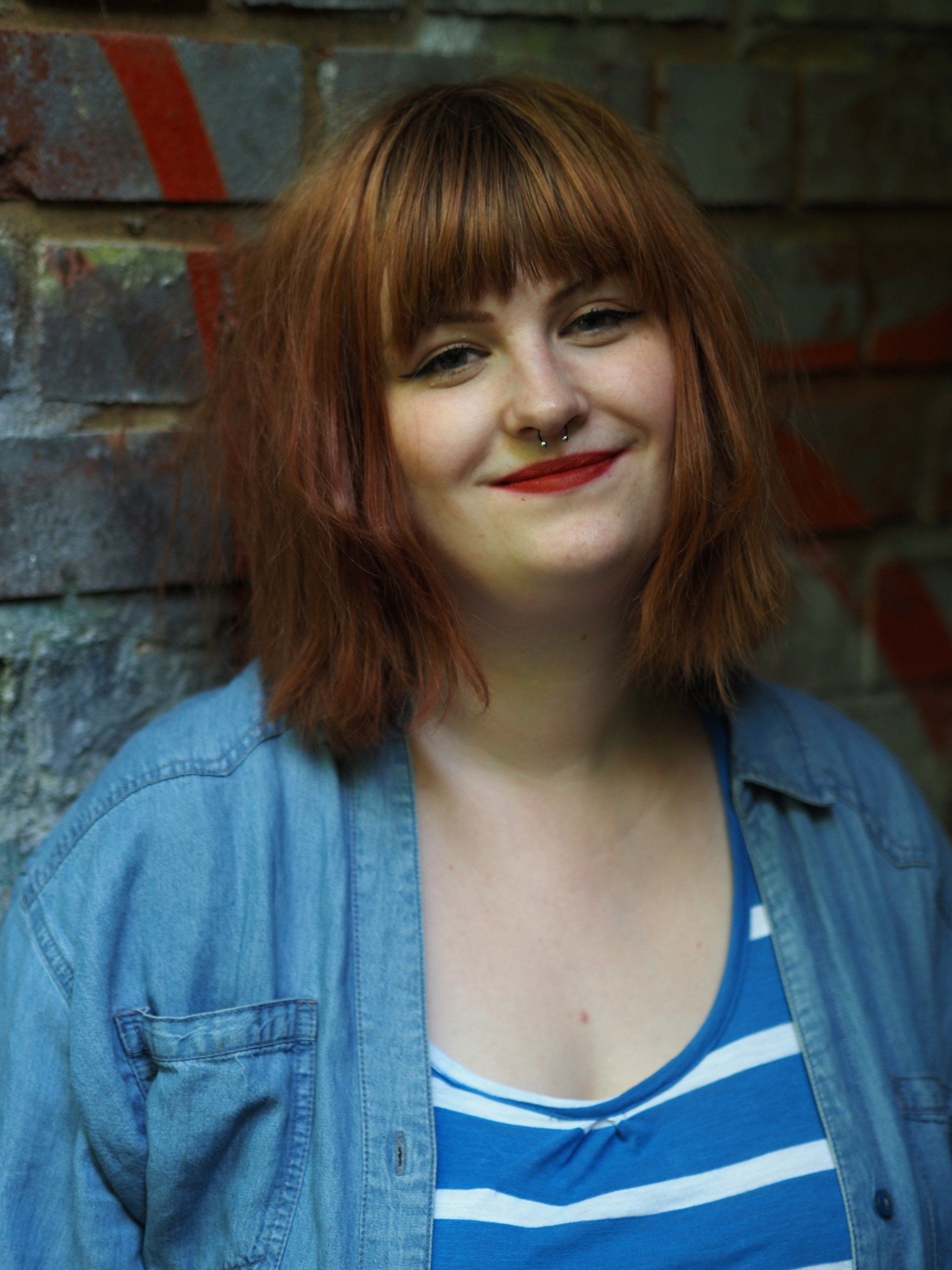 a portrait of a female model in the shade of a railway bridge