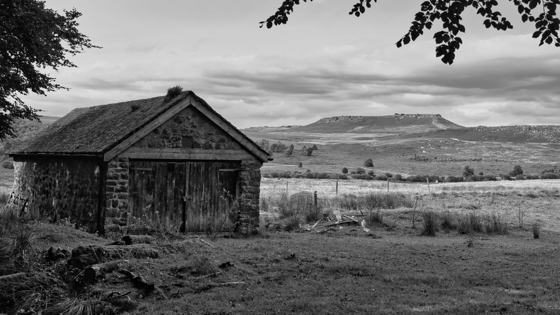 View to Stanage Edge across fields in monochrome