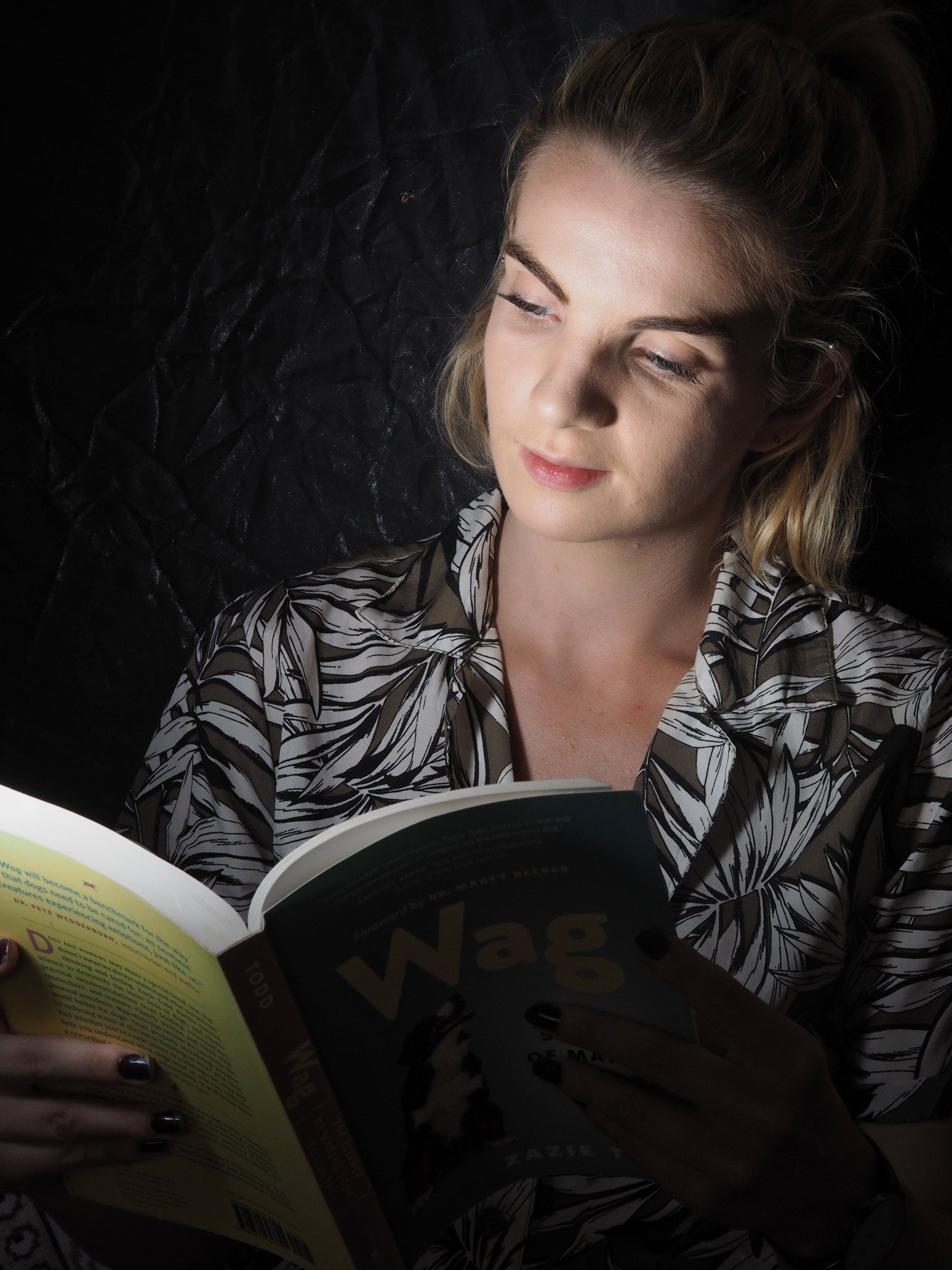 Photo by: Derek Smith a portrait of a young lady reading a book