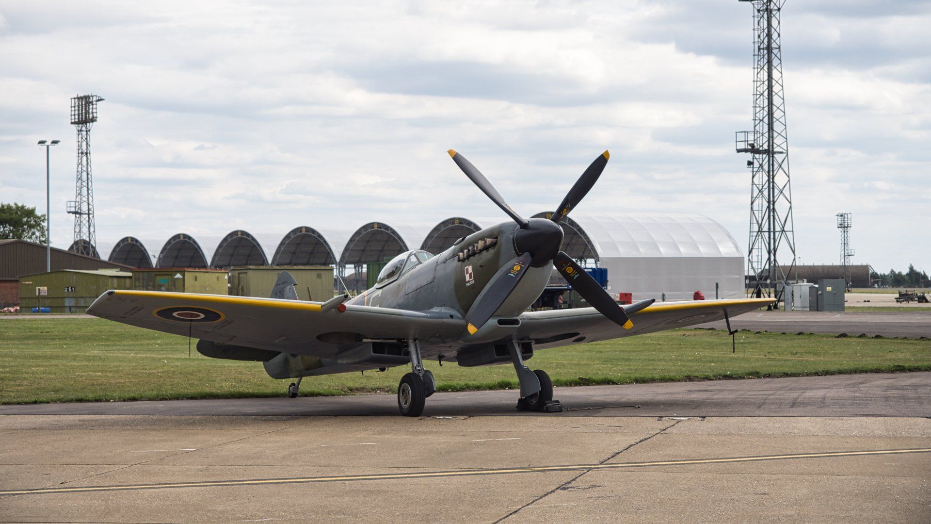 Spitfire Mk XVI TE311 by: Derek Smith a spitfire aircraft on the apron