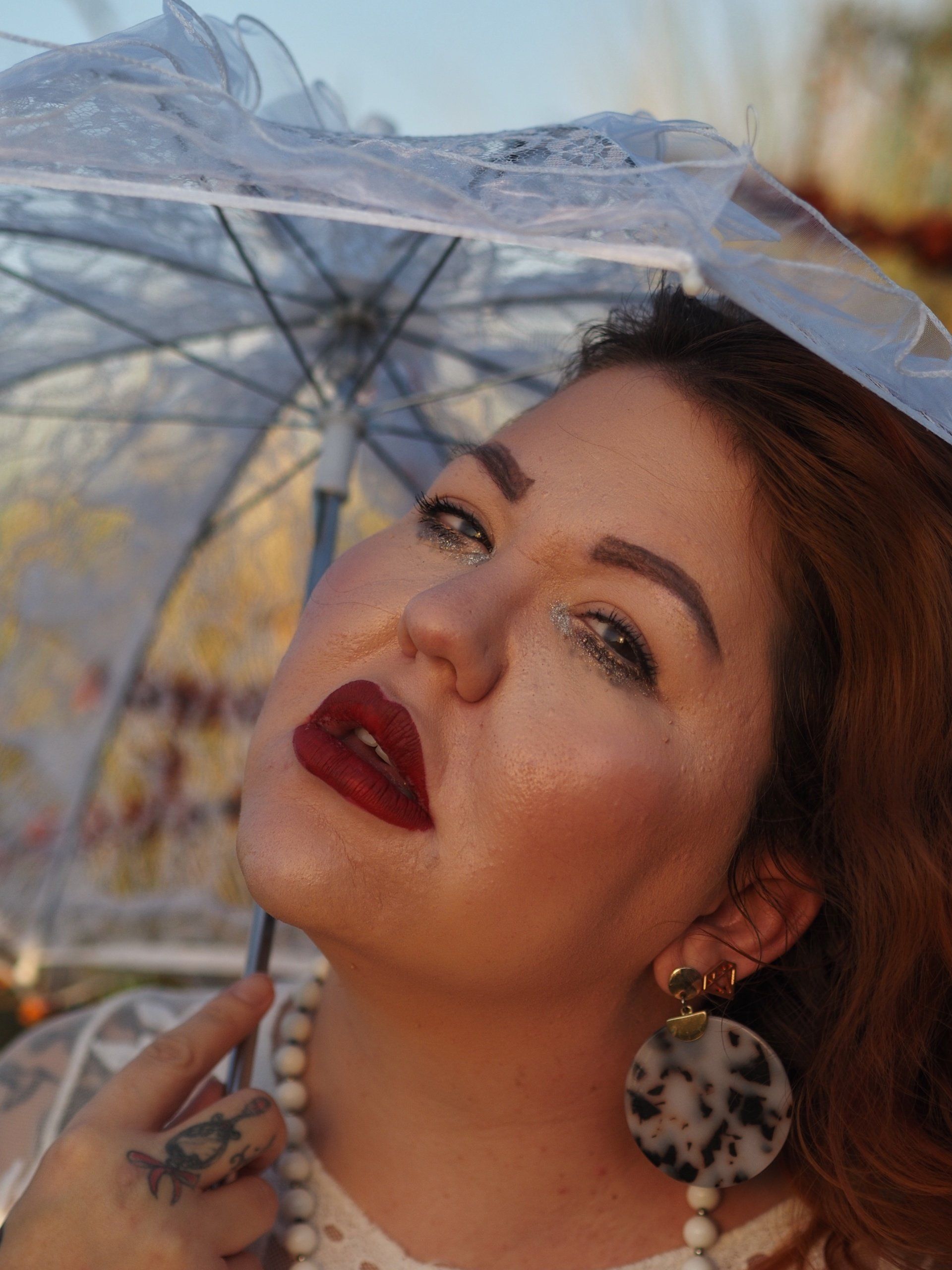 a young female model under a parasol