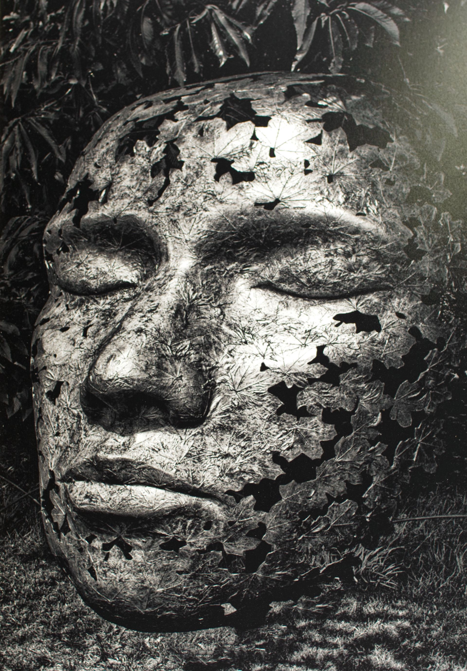 A monochrome photo of a sculpted face