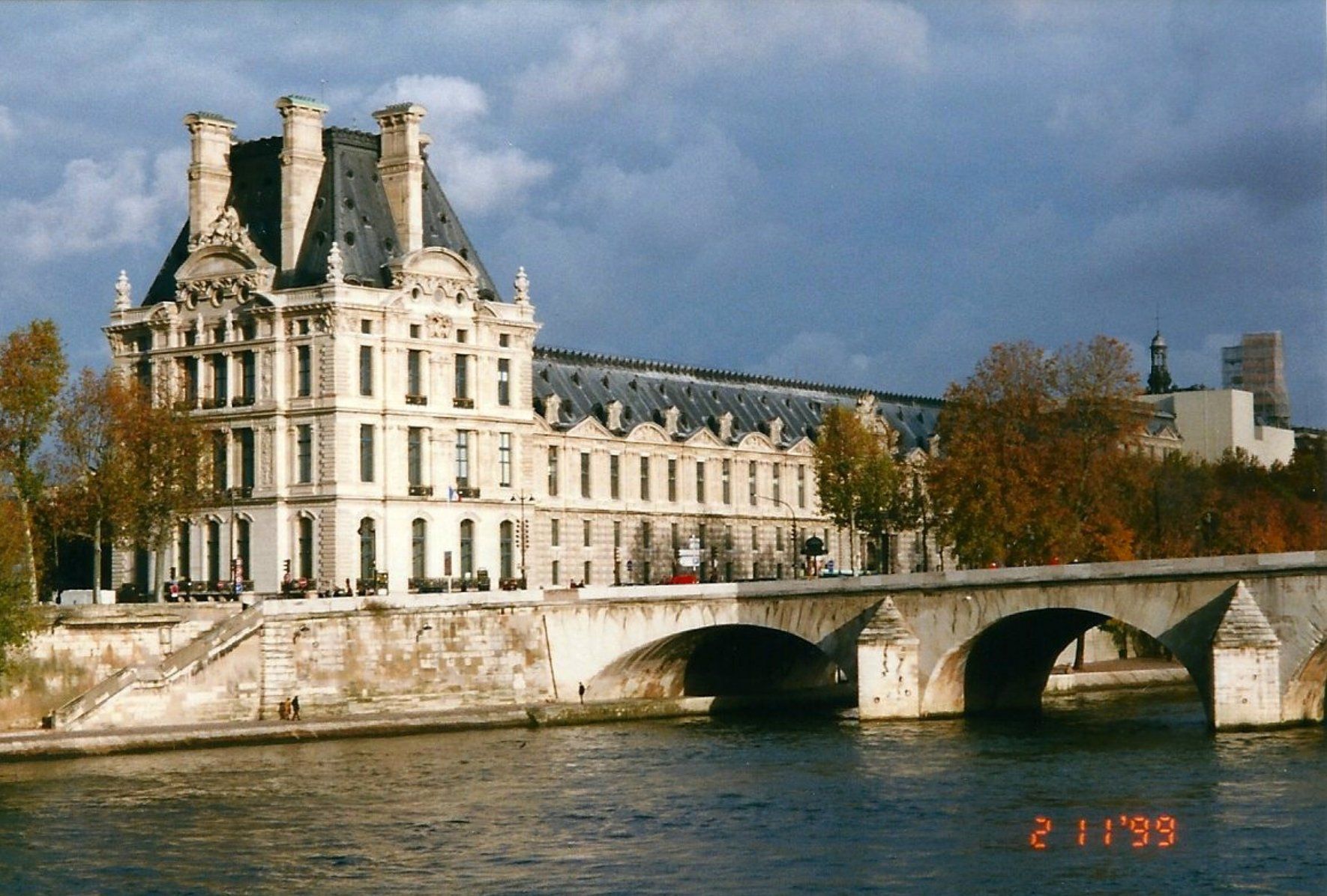 photo of the louvre in paris taken across the seine