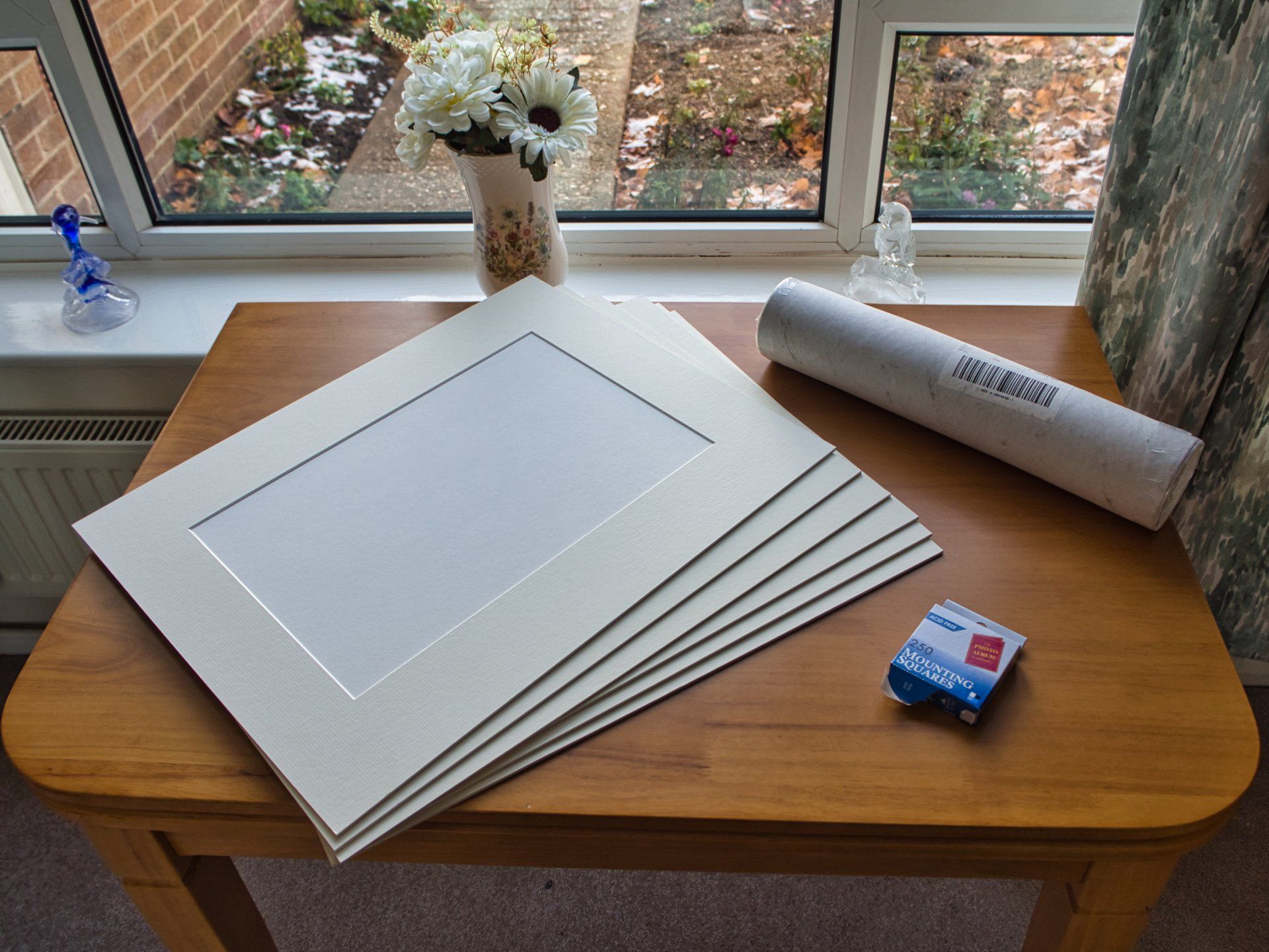 Photo by Derek Smith print mounts, and prints in a tube on a table