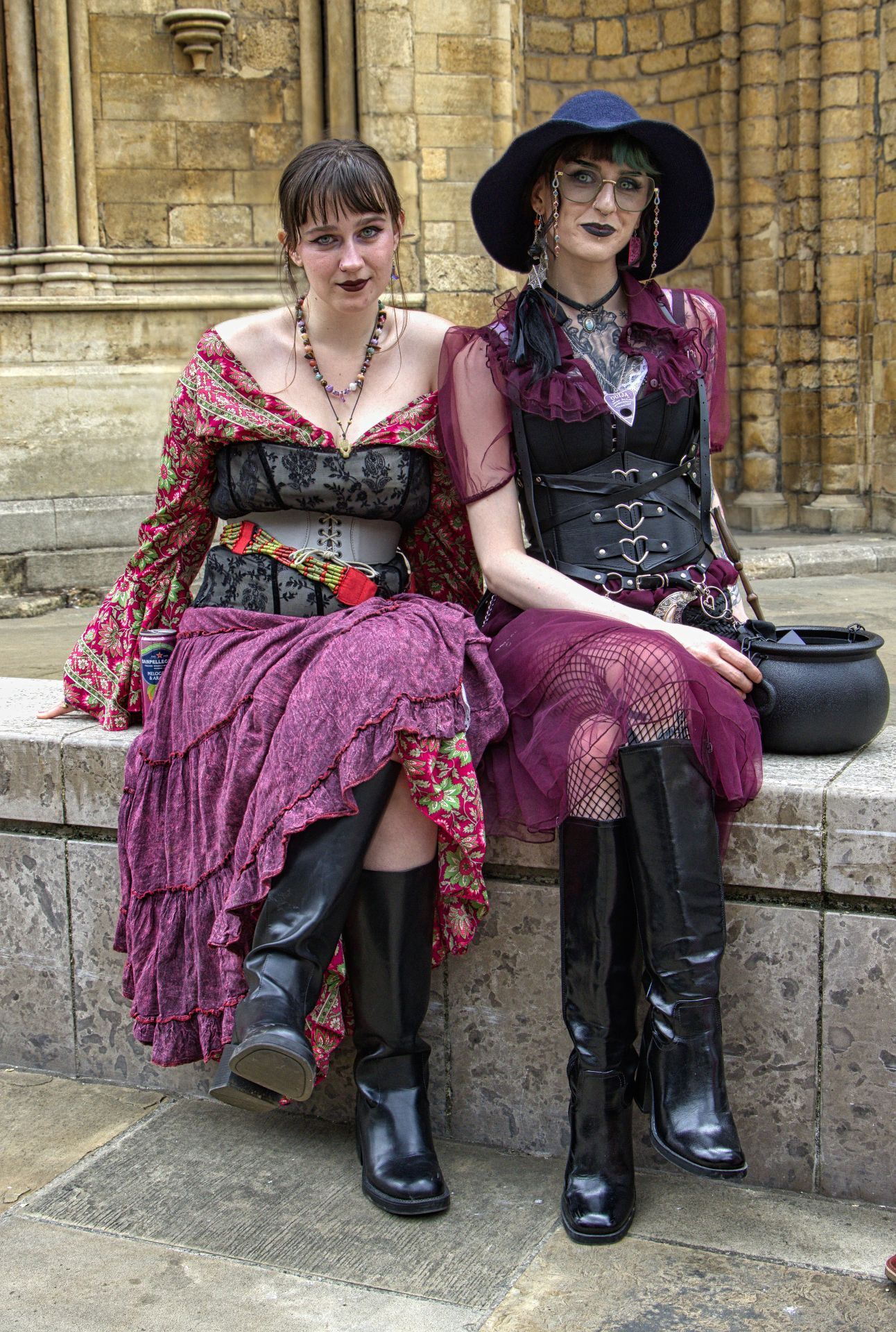 Two ladies sitting on a wall