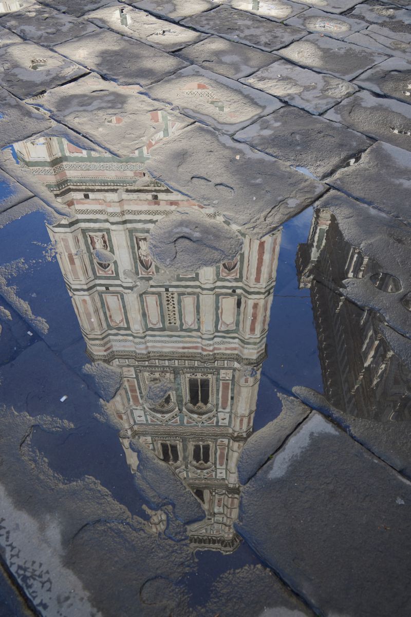 the bell tower of Florence cathedral reflected in water