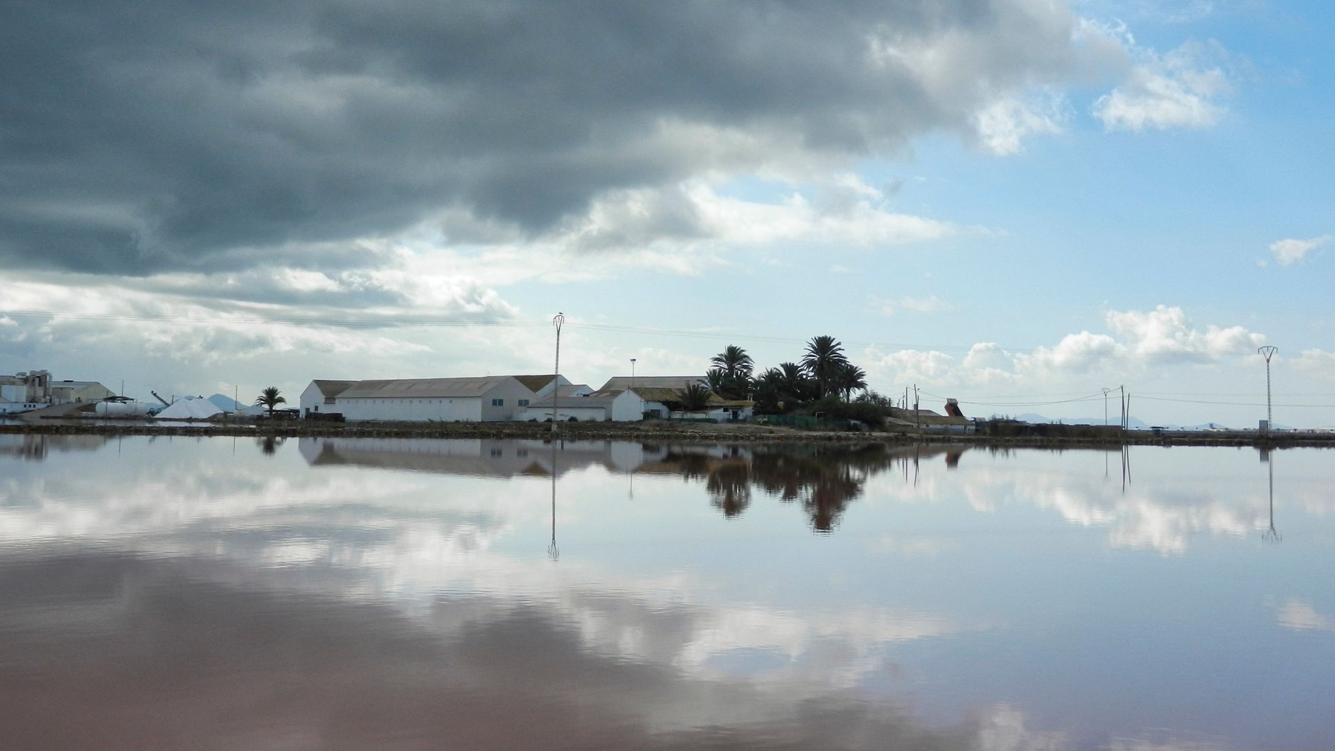 a salt works in Spain viewed across a saline lagoon