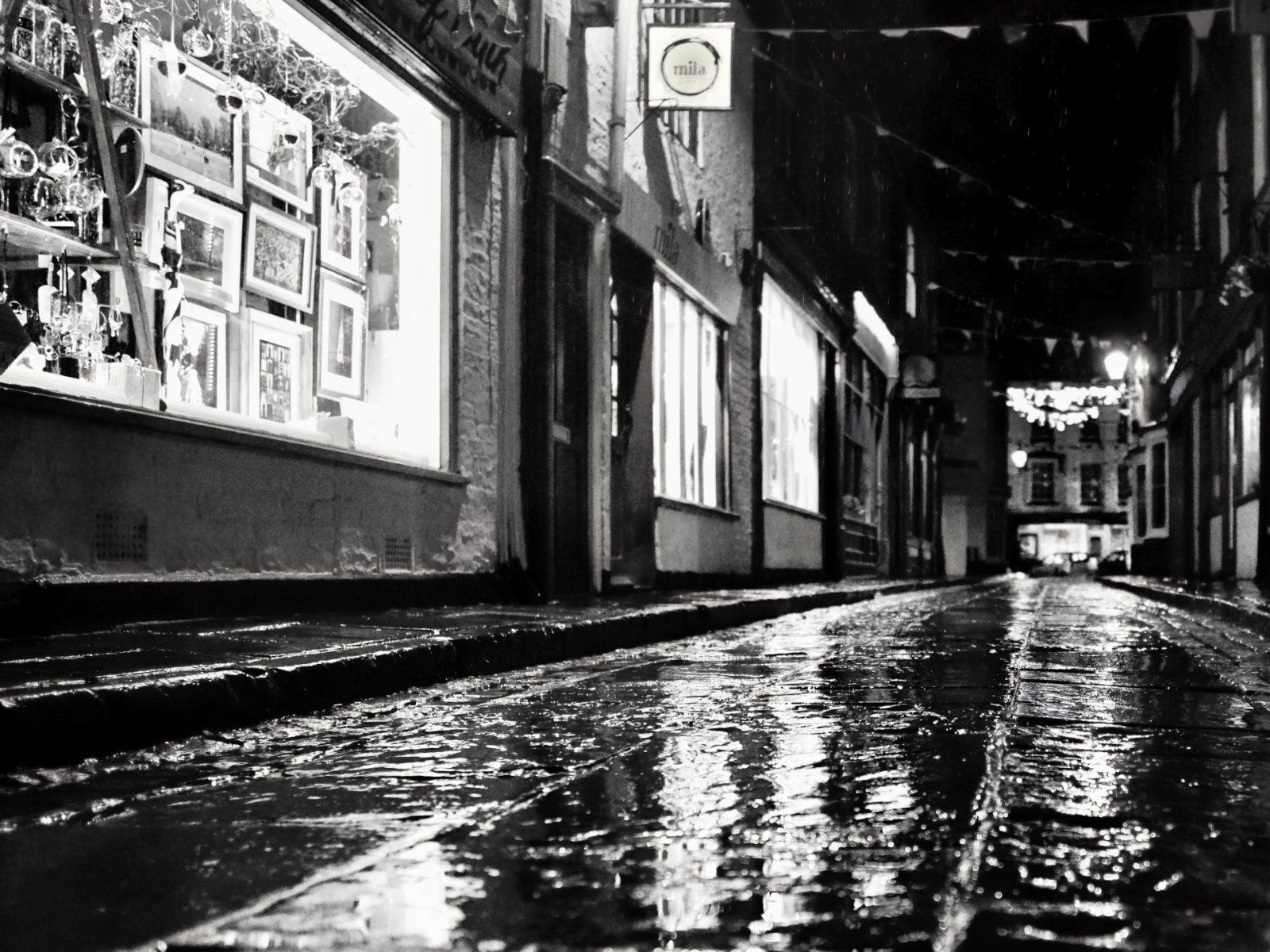 a view of wet cobbled streets at night