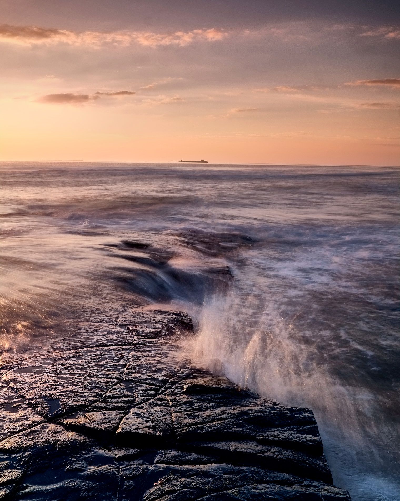 a seascape view of breaking waves in early sunshine