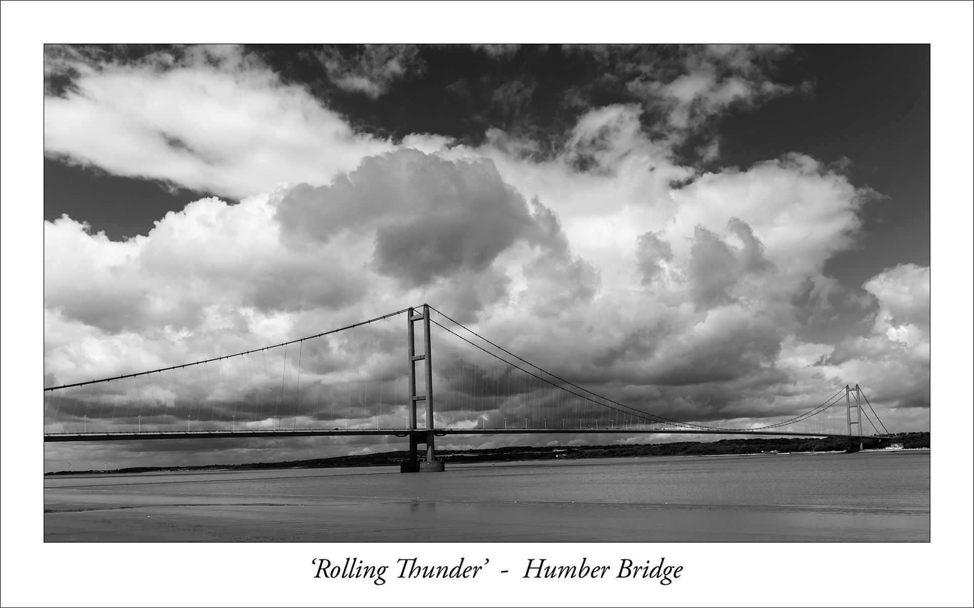 Photo by Paul Malley a storm cloud over the Humber Bridge rendered in monochrome