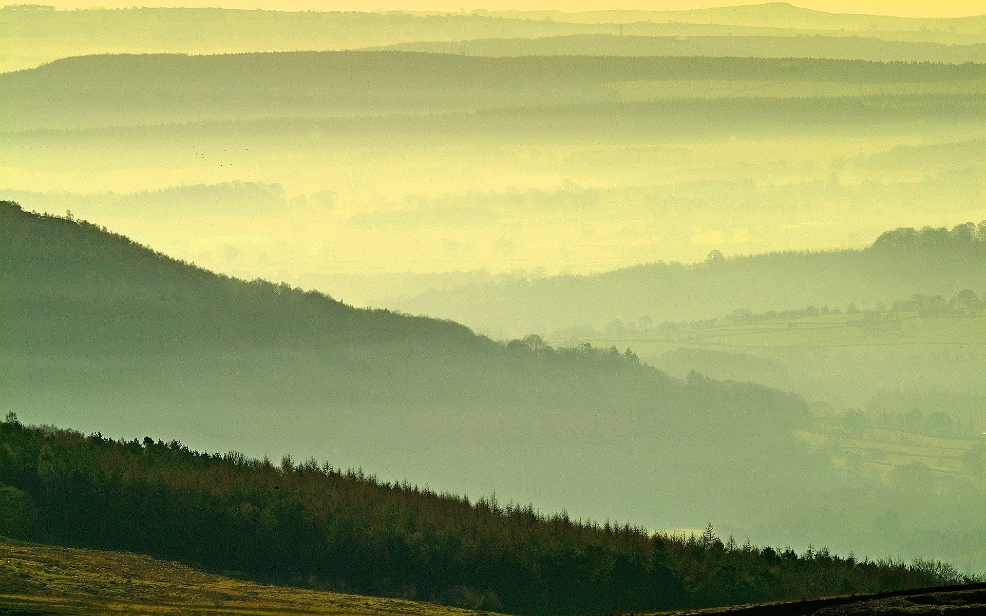 A view of a misty dawn over hills