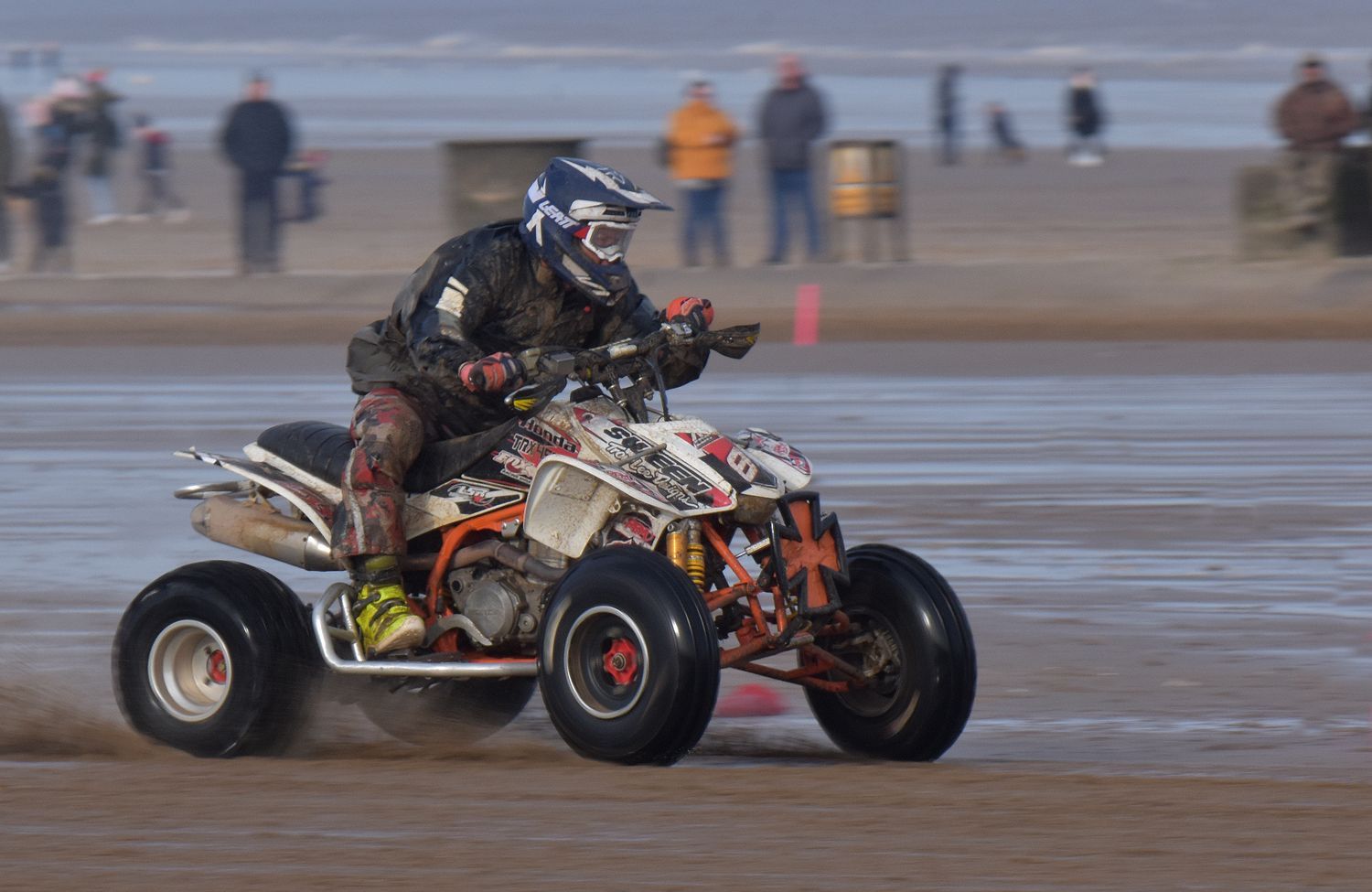 a quad bike racing on a beach