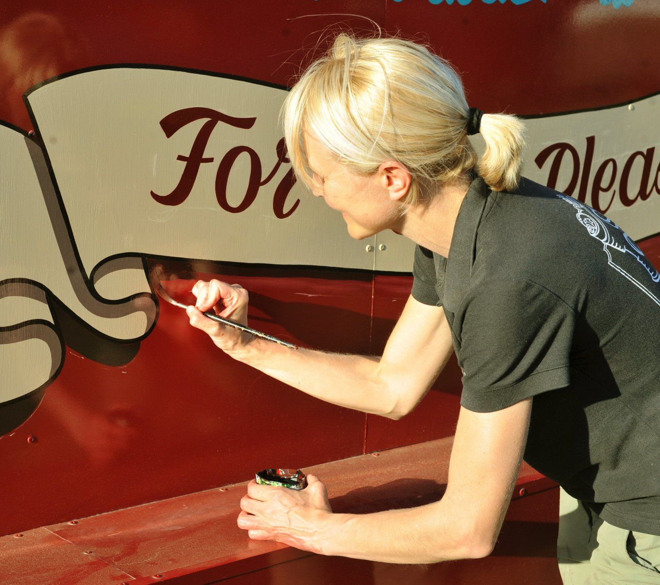 a sign writer working on a project