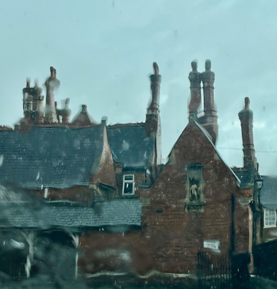 almshouses seen through a rainy window