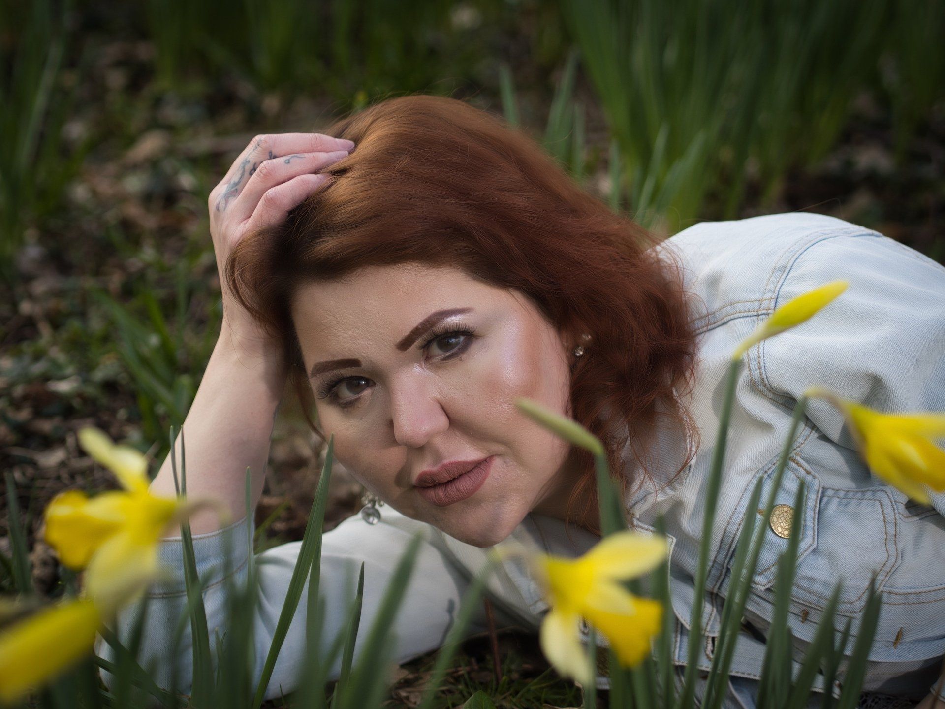 Rachel by Derek Smith a female model laying among the spring daffodils