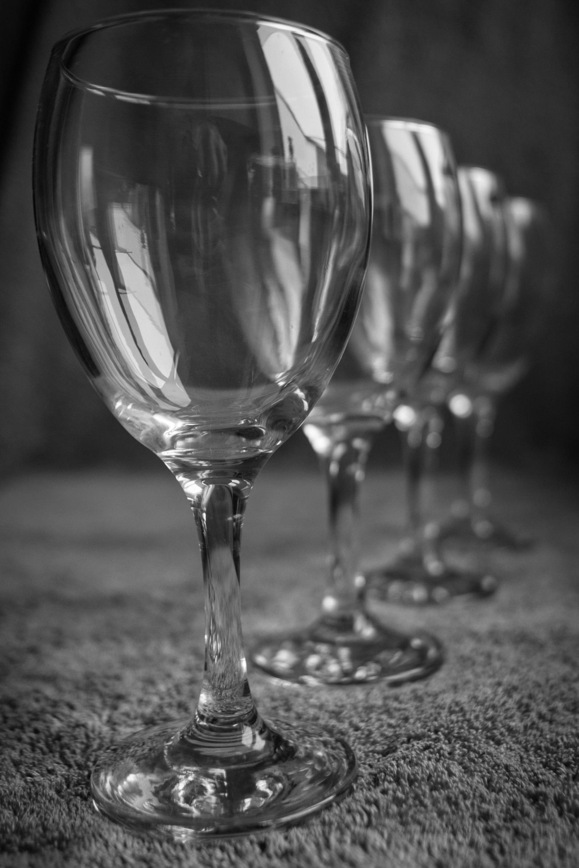a monochrome image of wine glasses