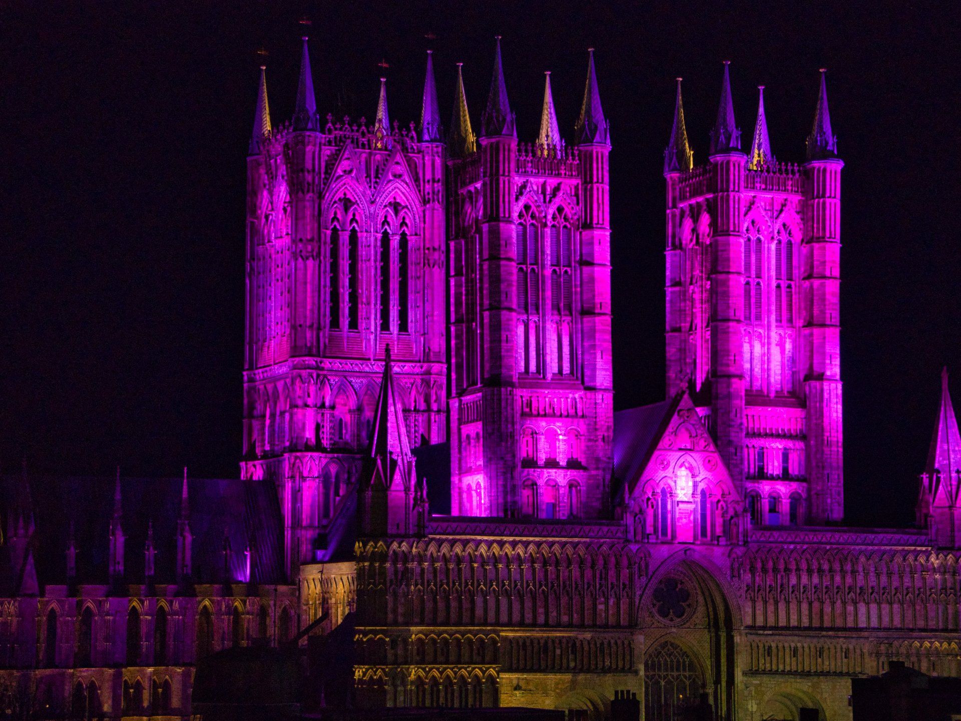 an illuminated lincoln cathedral at night