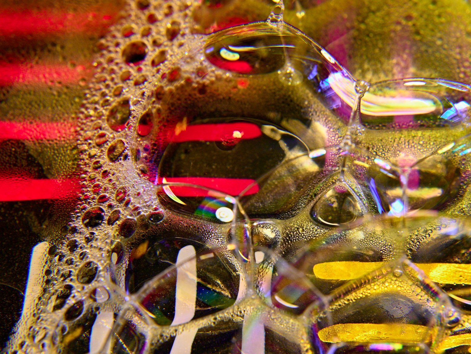 a creative image taken through a glass of water and washing up liquid