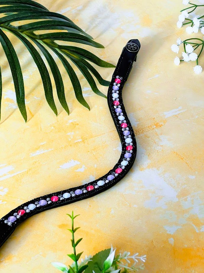 Let every hoofbeat echo with brilliance. Elite Cupcake crystal browband. Hotfix crystals in Pink, Lilac, Rainbow and Silver with black sparkle trim. Italian leather. Quick-change with anti-slip grip. Anatomical u-shape fit. Small pony and pony sizes. By Ice Equestrian.