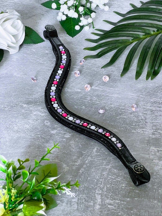 Let every hoofbeat echo with brilliance. Elite Cupcake Delight crystal browband. Hotfix crystals in Pink, Lilac, Rainbow and Silver with black sparkle trim. Italian leather. Quick-change with anti-slip grip. Wide anatomical deep u-shape fit. Small pony and pony sizes. By Ice Equestrian.