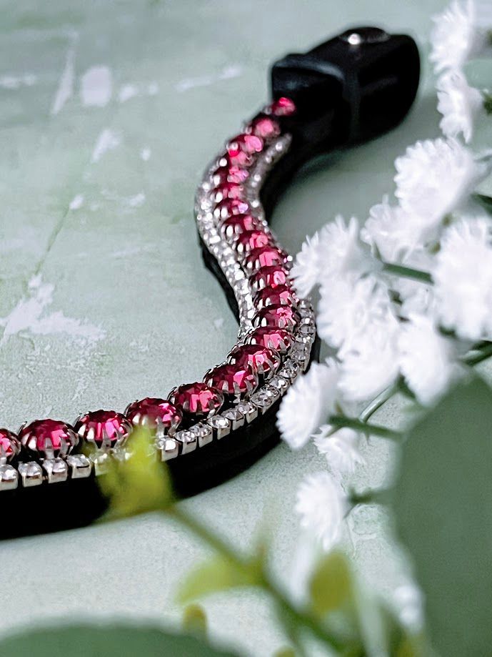 Let every hoofbeat echo with brilliance. Raspberry Rapture premium European leather Preciosa crystal browband. Triple-row design with 8mm central Rose Preciosa crystals beautifully framed by a 3mm crystal border. Adjustable quick-change with anti-slip grip. Anatomical deep U-shape fit. All sizes. By Ice Equestrian.