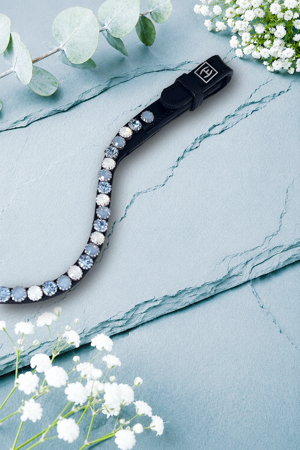 Let every hoofbeat echo with brilliance. Snow Fury premium European leather Preciosa crystal browband. 8mm Preciosa crystals in Light Sapphire, White Opal and Light Sapphire Opal. Adjustable quick-change with anti-slip grip. Slender anatomical deep U-shape fit. All sizes. By Ice Equestrian.