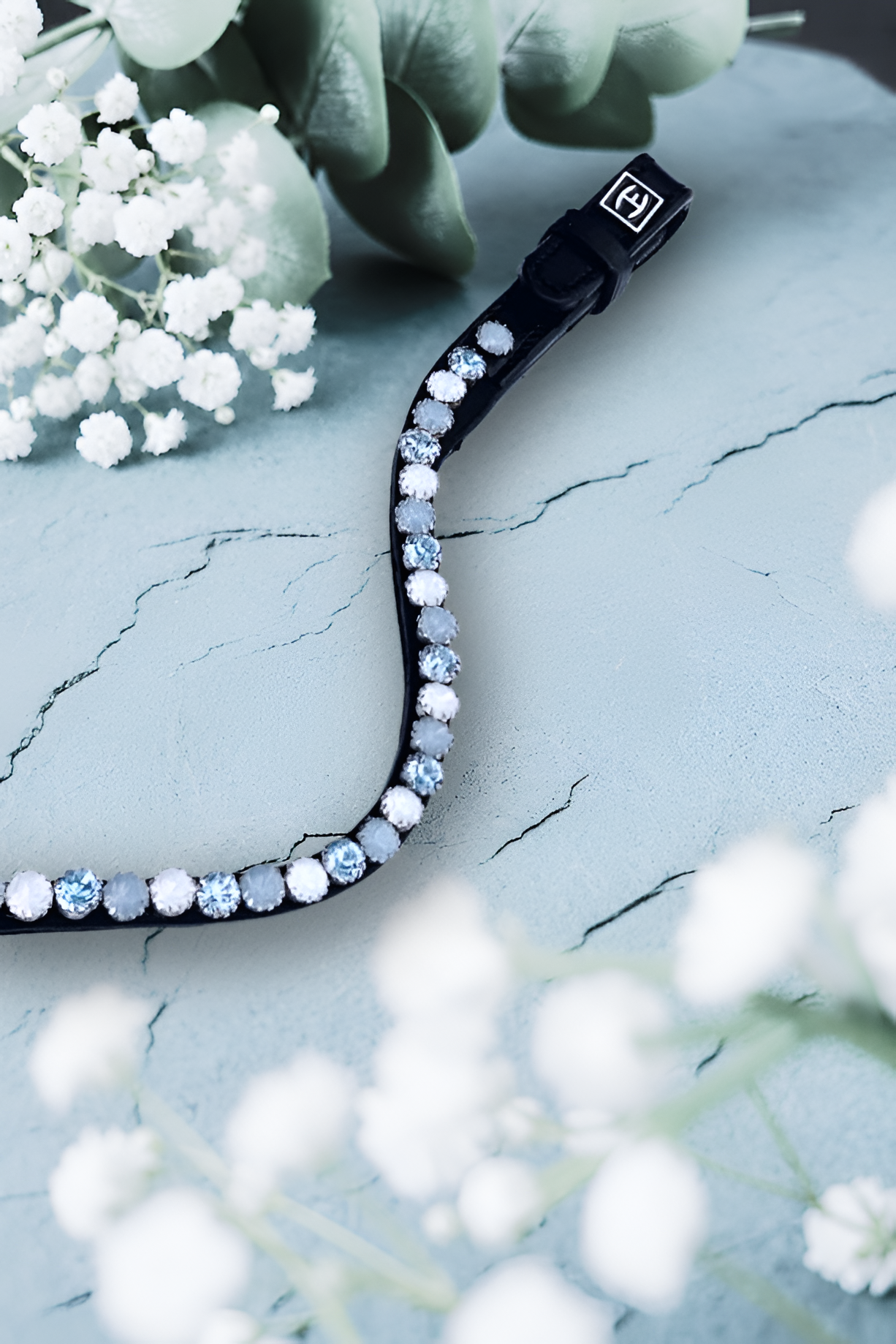 Let every hoofbeat echo with brilliance. Snow Fury premium European leather Preciosa crystal browband. 8mm Preciosa crystals in Light Sapphire, White Opal and Light Sapphire Opal. Adjustable quick-change with anti-slip grip. Slender anatomical deep U-shape fit. All sizes. By Ice Equestrian.