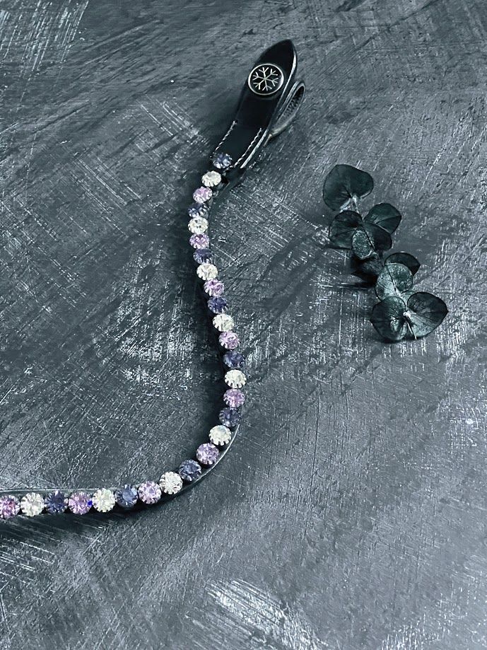 Let every hoofbeat echo with brilliance. Elite Indigo crystal browband. 8mm Preciosa crystals in Purple Velvet, Tanzanite and Crystal. Italian leather. Quick-change with anti-slip grip. Slender anatomical deep u-shape fit. All sizes. By Ice Equestrian.