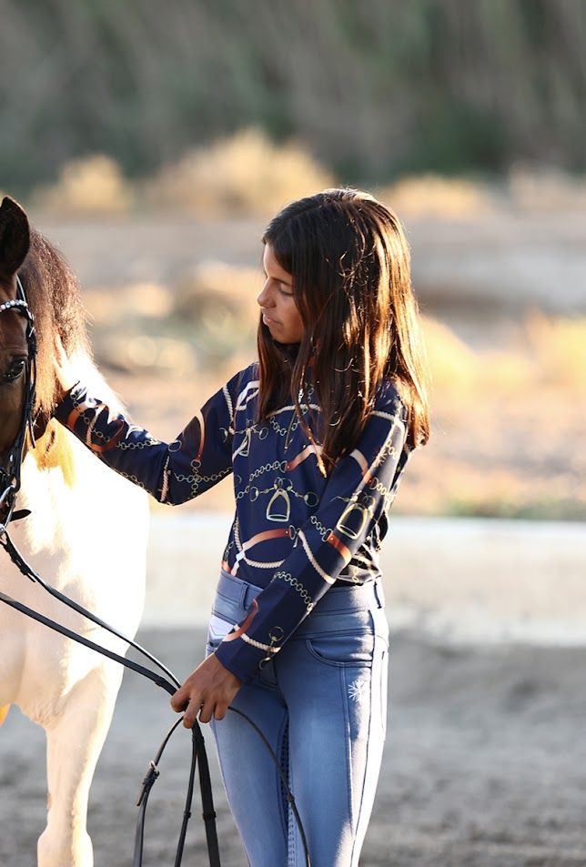 Discounted pacific young rider base layer training top. Moisture-wicking 4-way stretch fabric with high collar and built-in UV protection. By Ice Equestrian