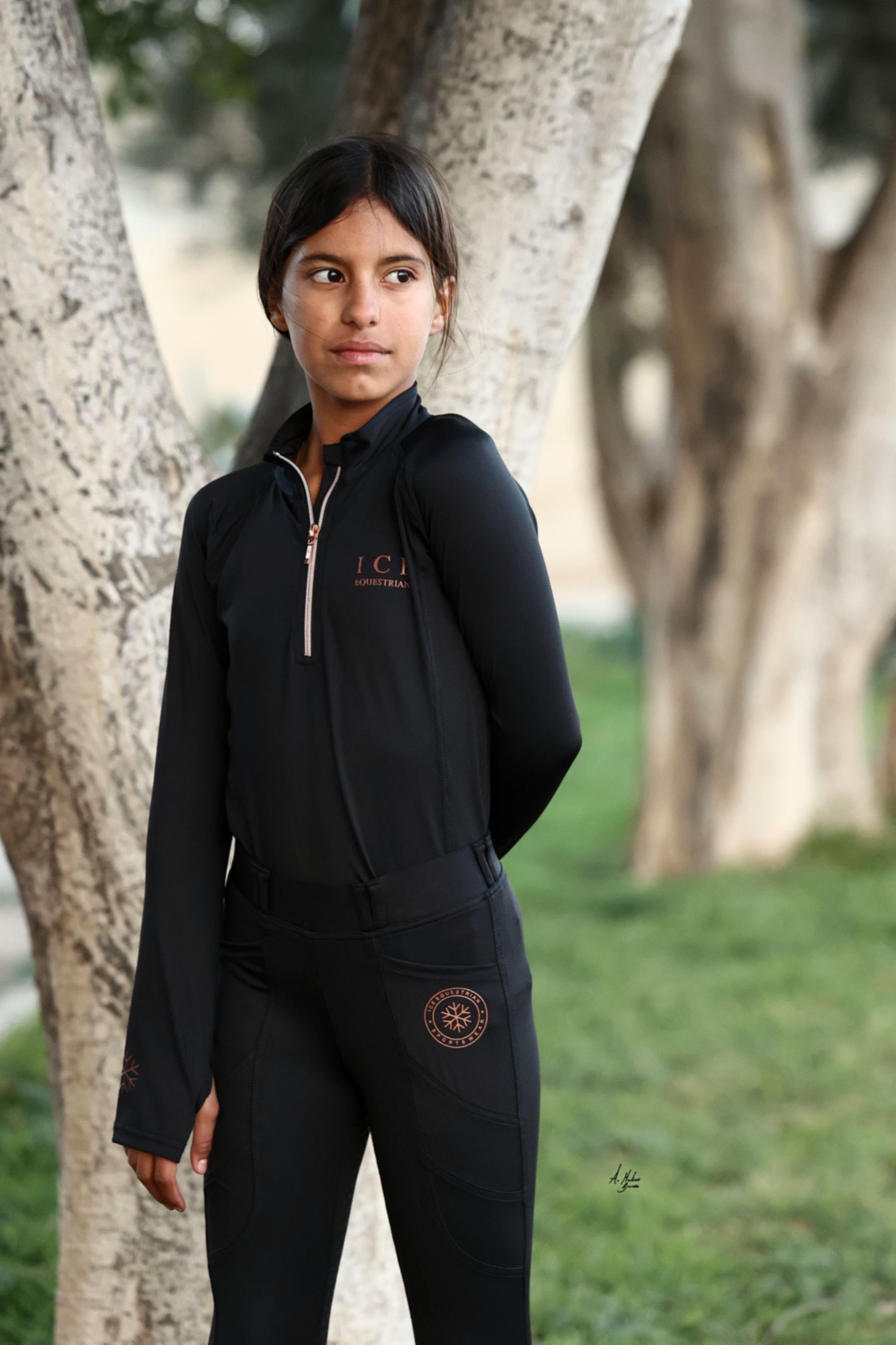 Discounted Black Kadie young rider everyday base layer. Thicker 4-way stretch fabric with integrated thumb holes and half-zip. By Ice Equestrian