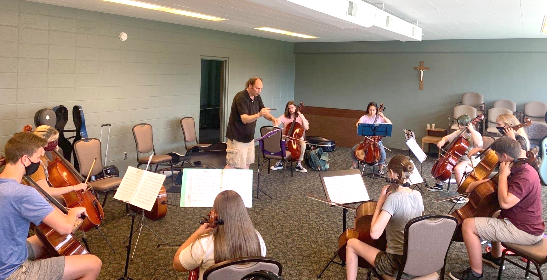 Student cellists playing in cello ensemble.