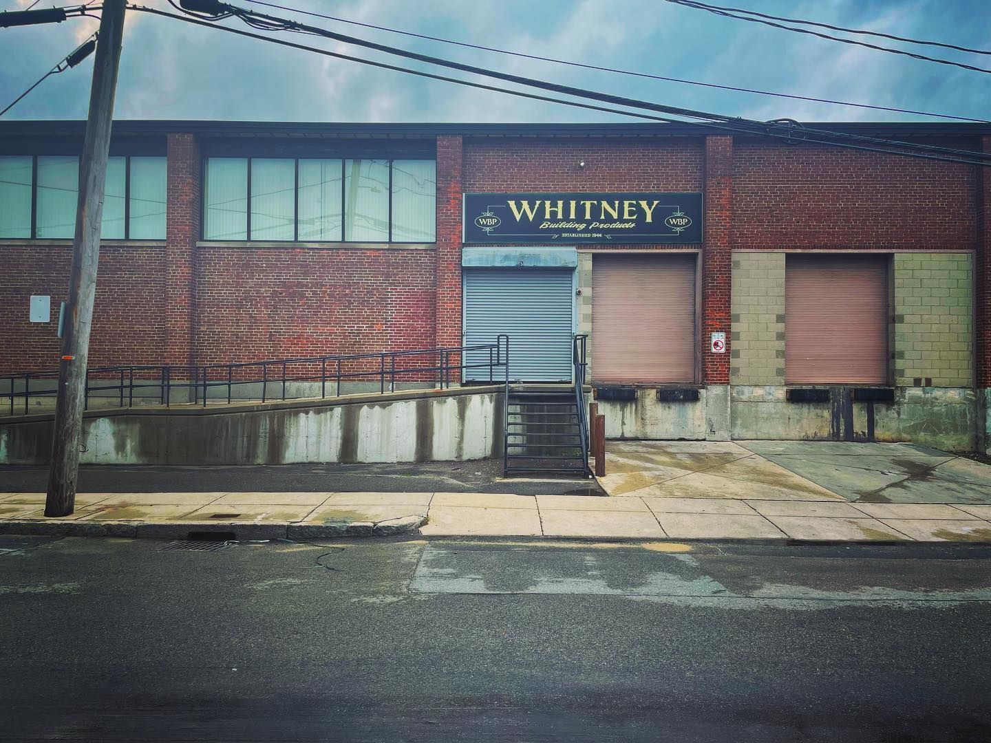 Fully restored gold leaf and hand painted facade sign for construction company in Dorchester, MA.