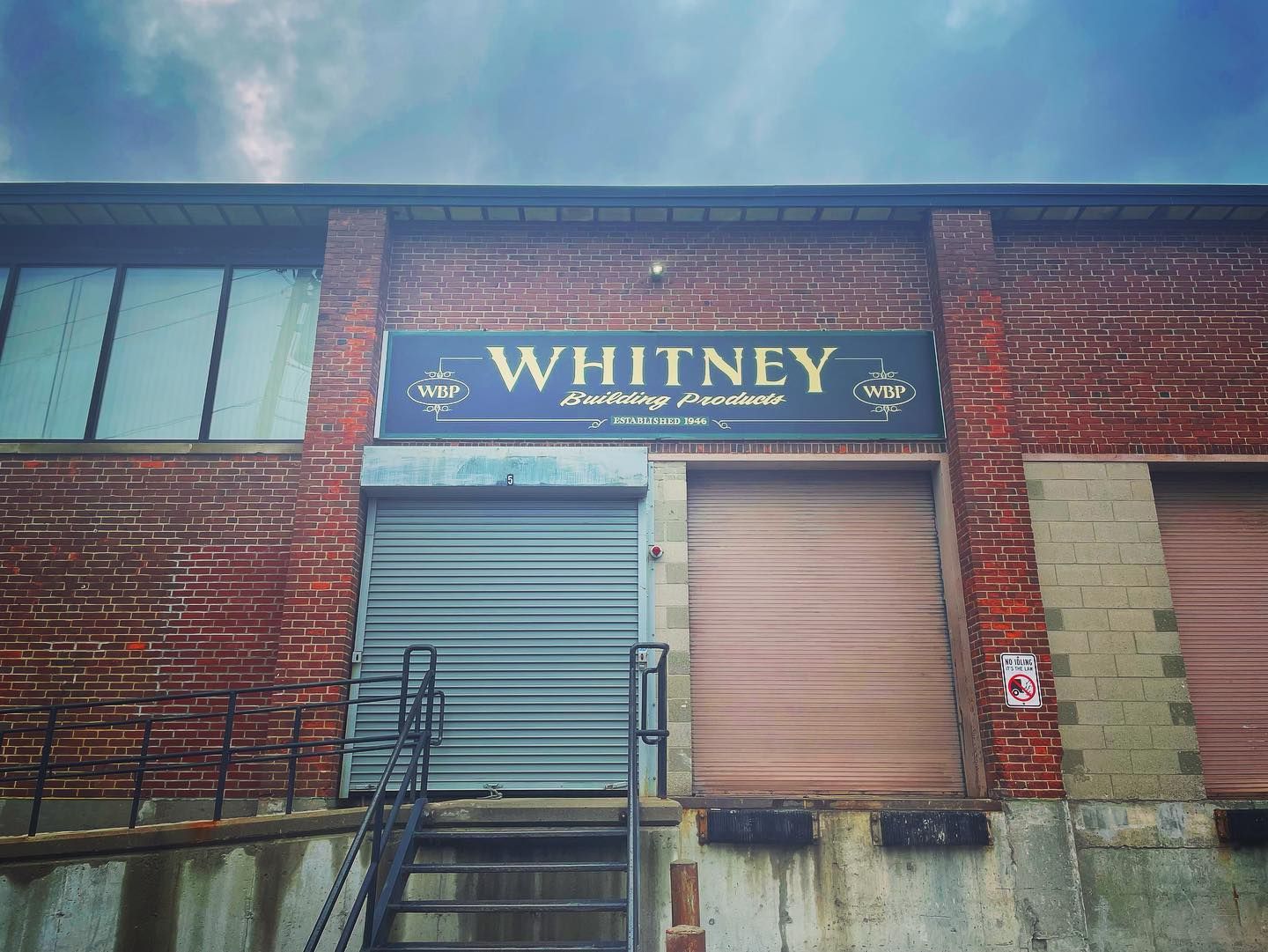 Fully restored gold leaf and hand painted facade sign for construction company in Dorchester, MA.