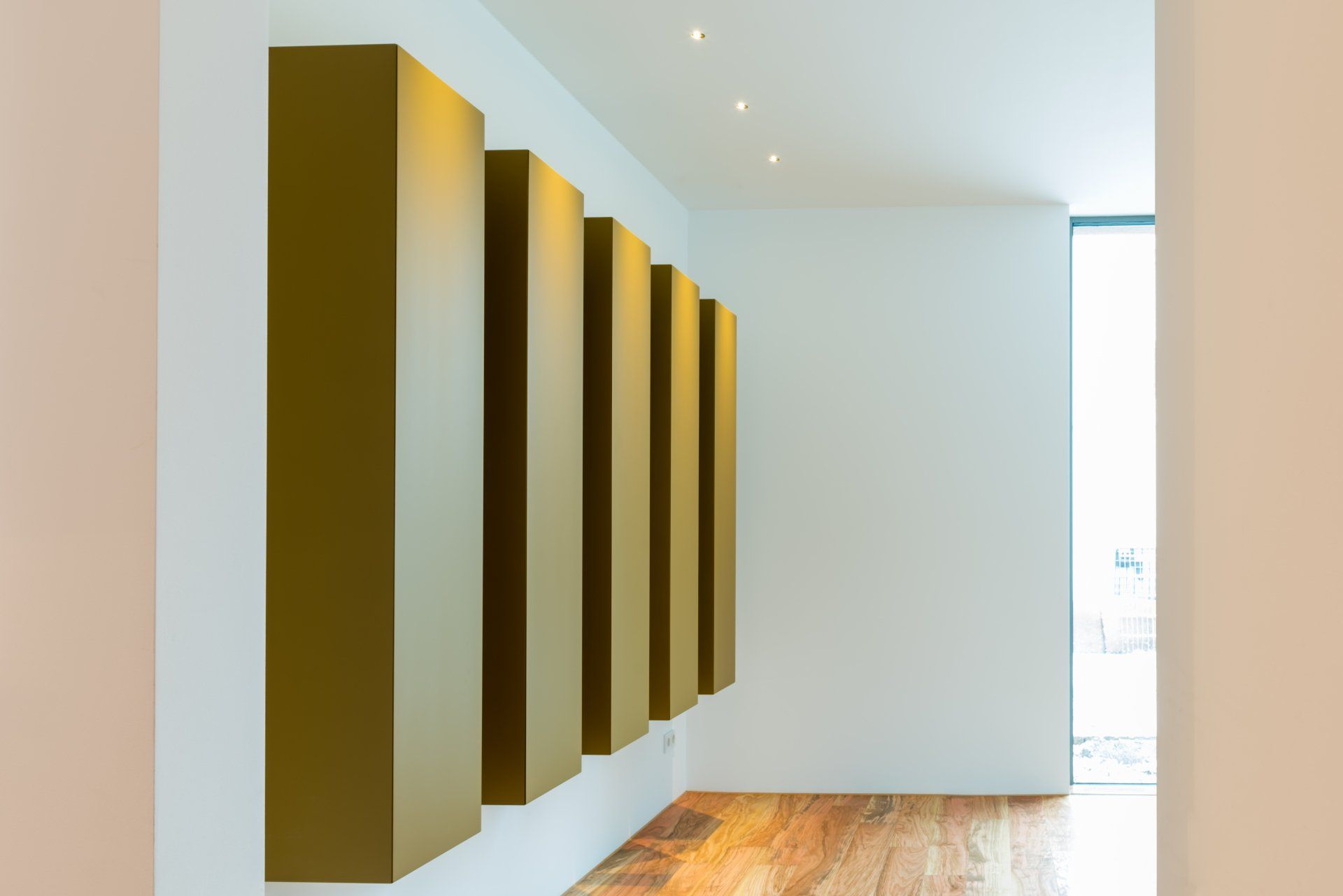 Fünf längliche Schrankkorpusse an einer Wand