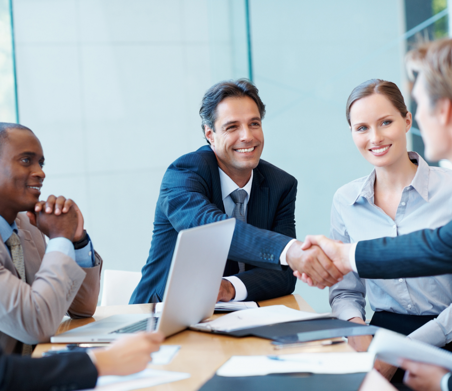 Diverse group of professionals collaborating on a project in a modern office